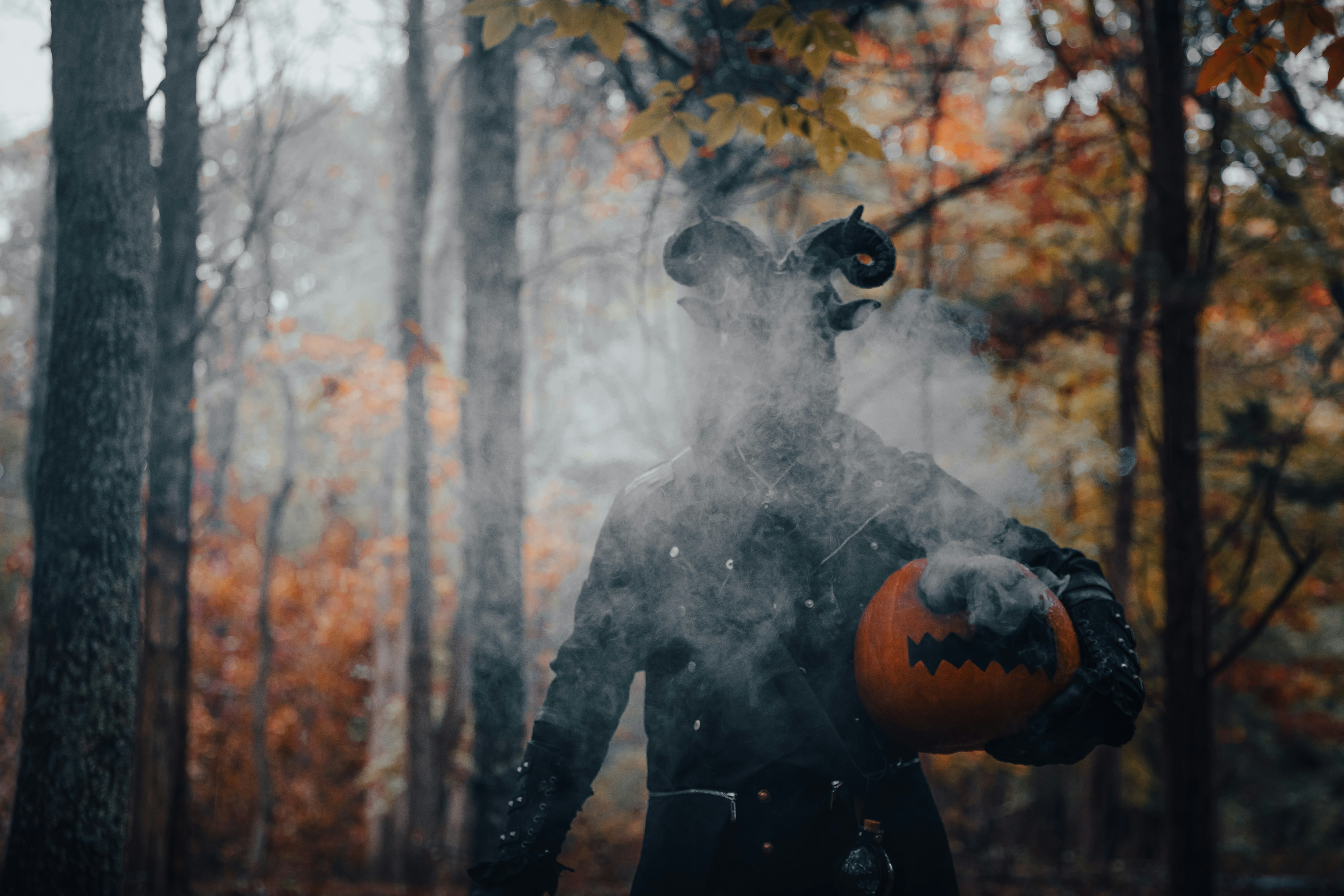 Dark Spooky Figure Holding A Pumpkin In A Misty Autumn Forest. 4K Wallpaper #3629