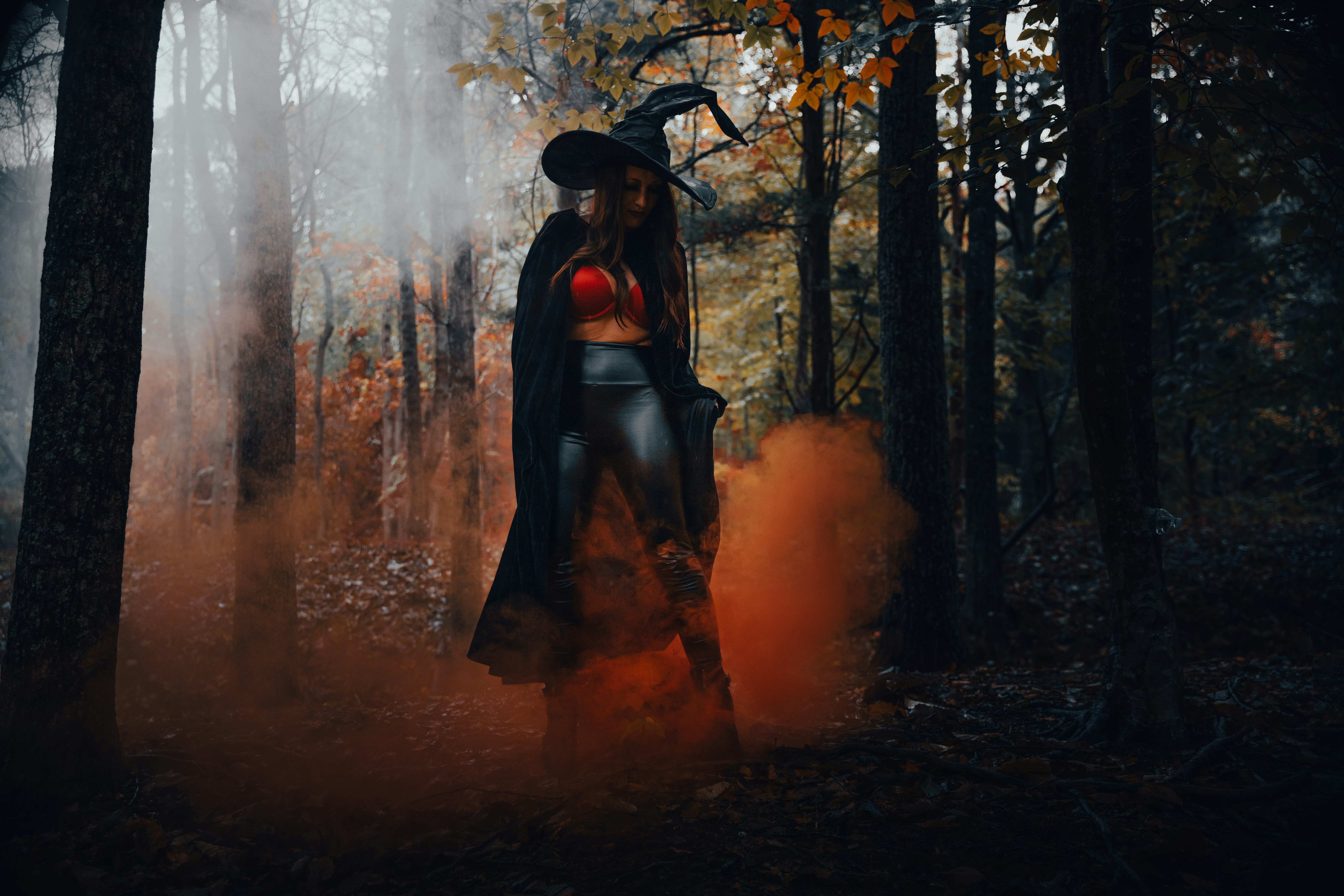 Dark A Witch In A Forest With Orange Smoke. 4K Wallpaper #3630
