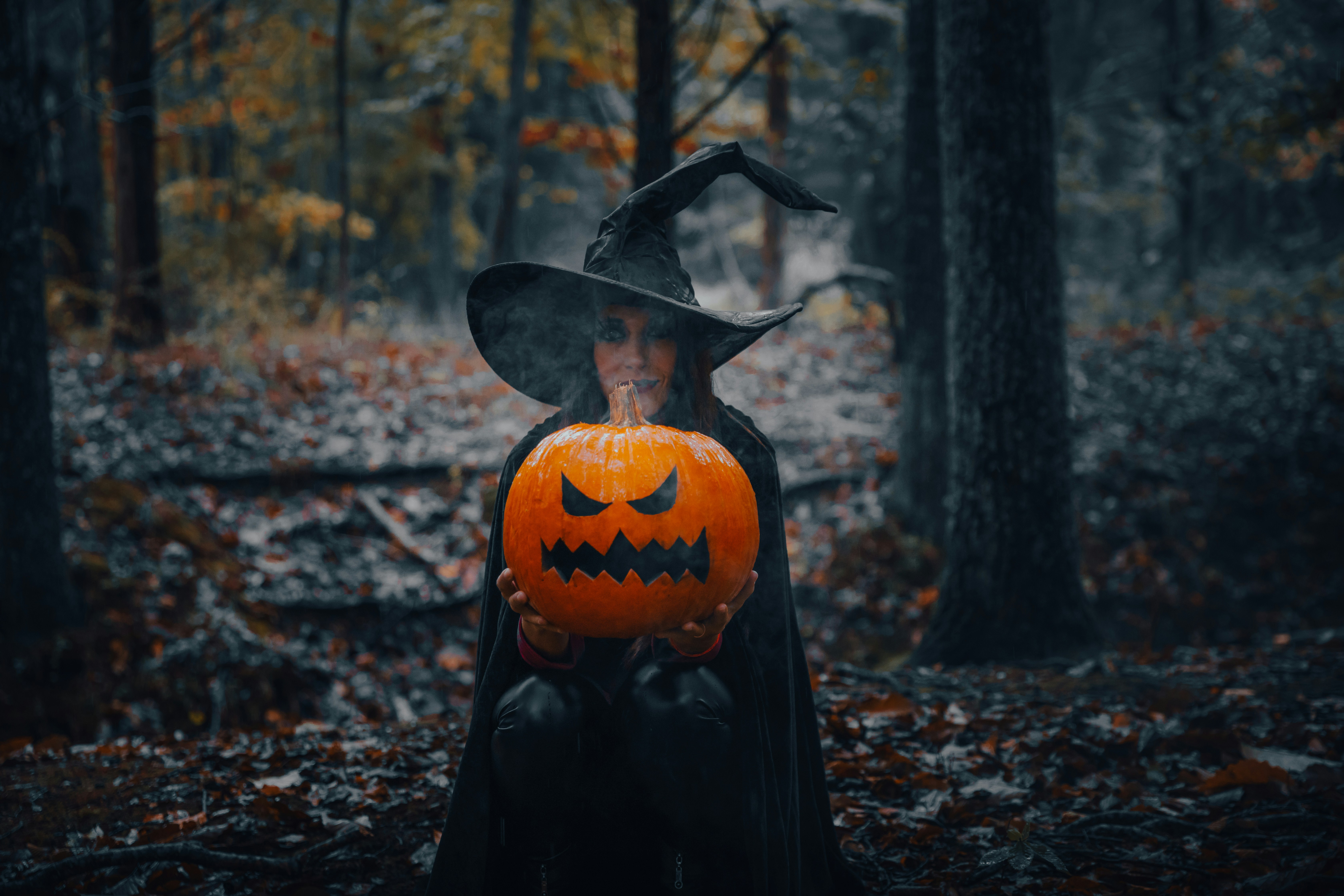 Dark A Witch In A Dark Forest Holding A Glowing Jack O' Lantern. 4K Wallpaper #3632