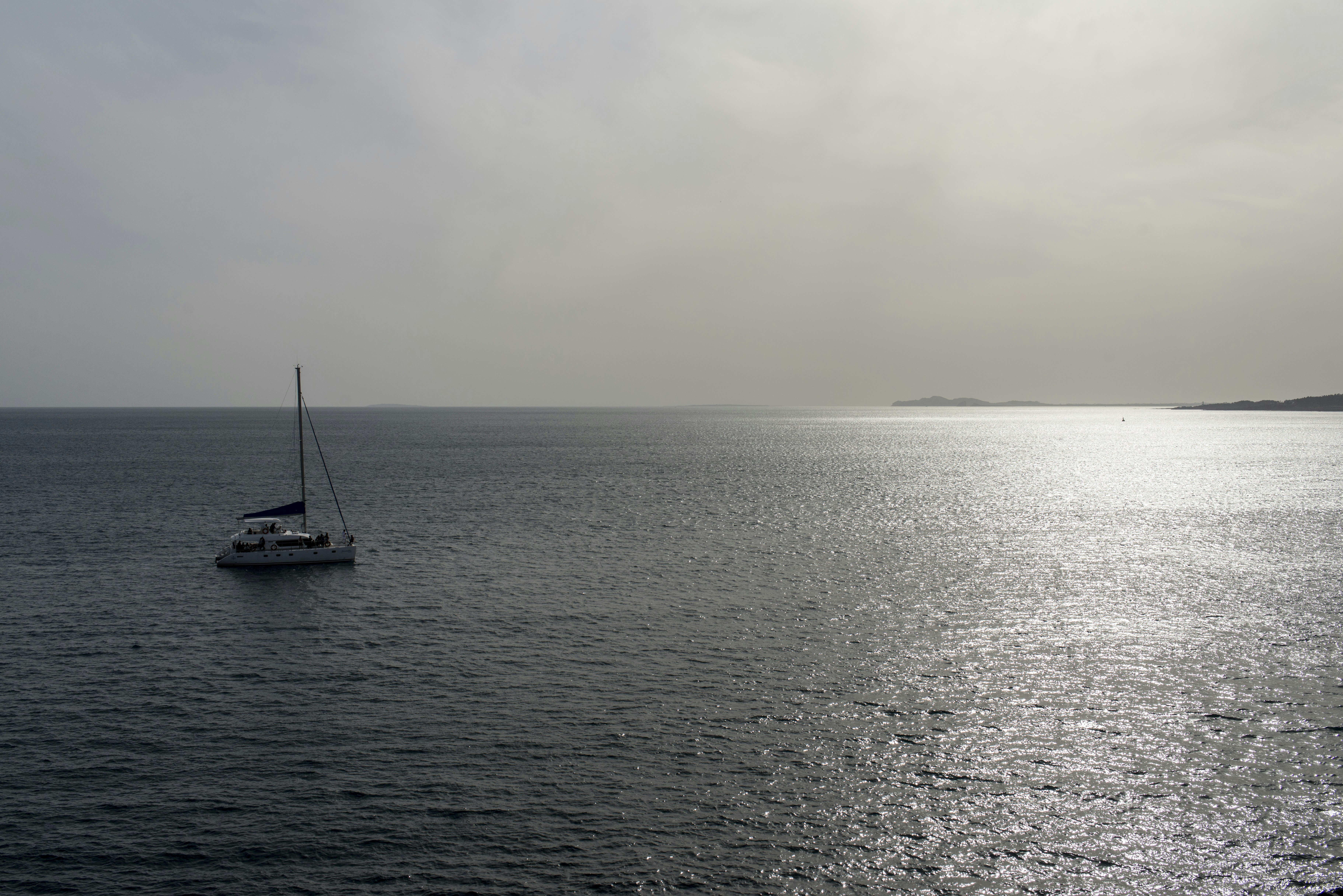 Ocean A Sailboat On Shimmering Water Under A Hazy Sky. 4K Wallpaper #3607