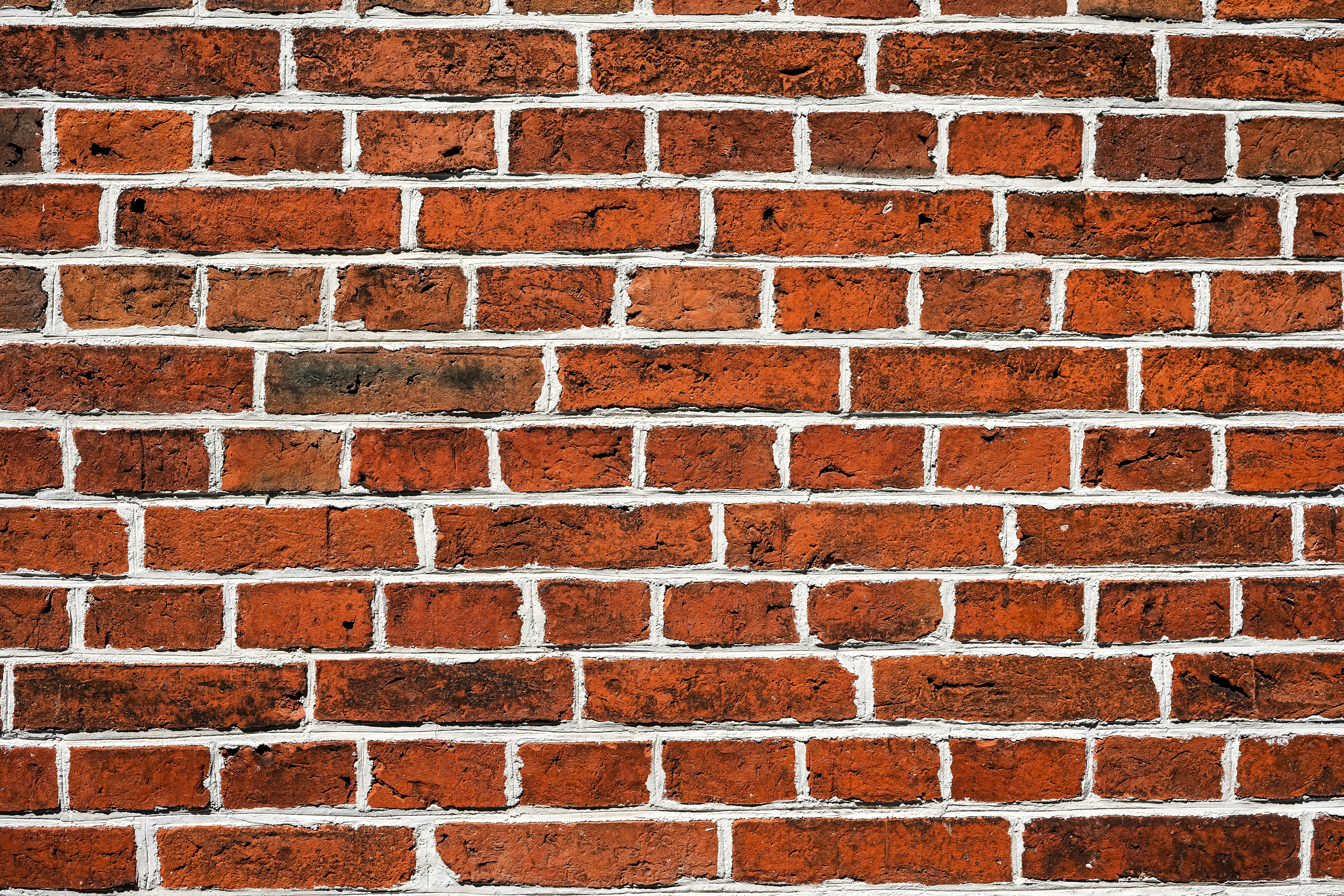 Red brick wall with white mortar.