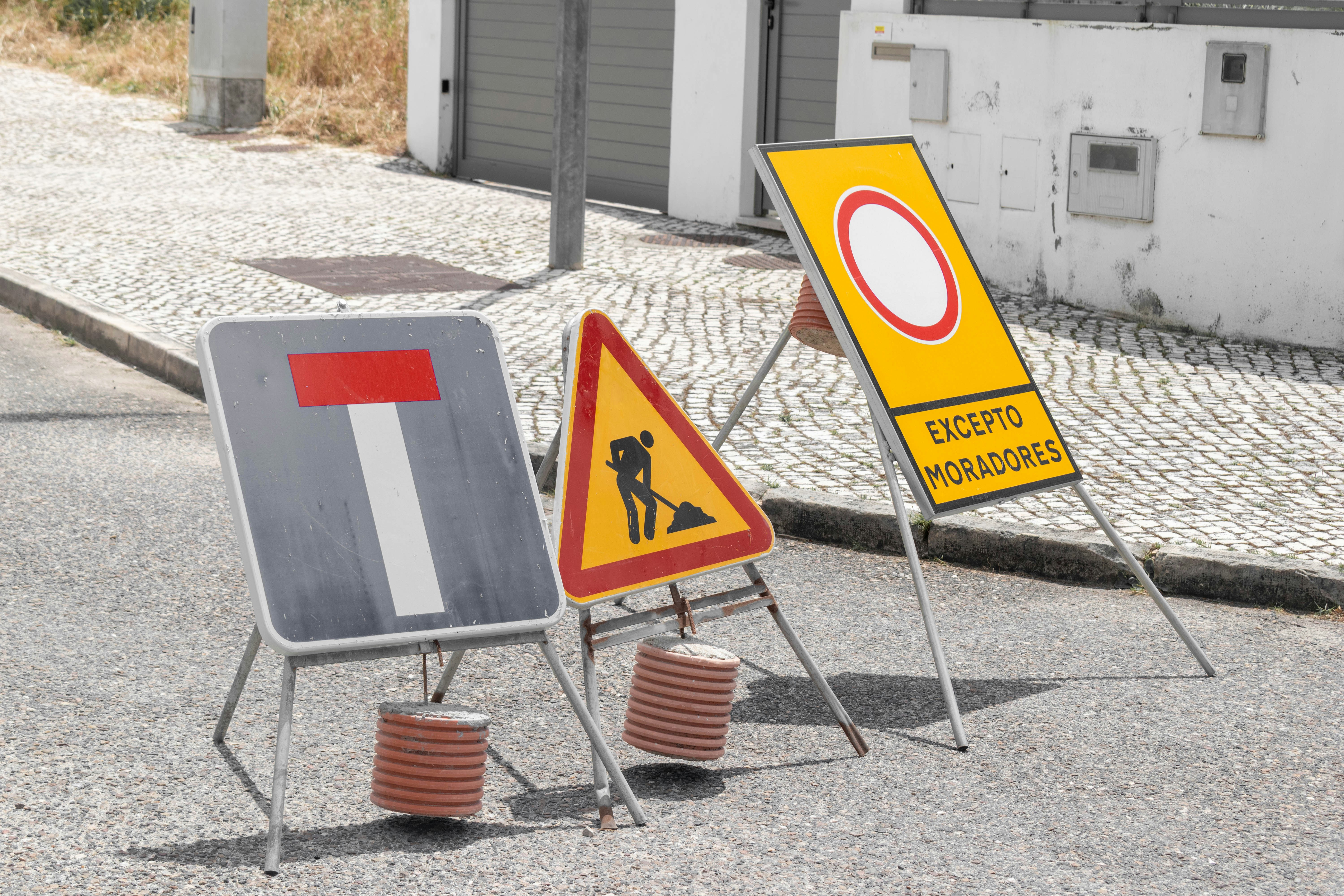 Various road signs indicating dead-end, construction, and limited access