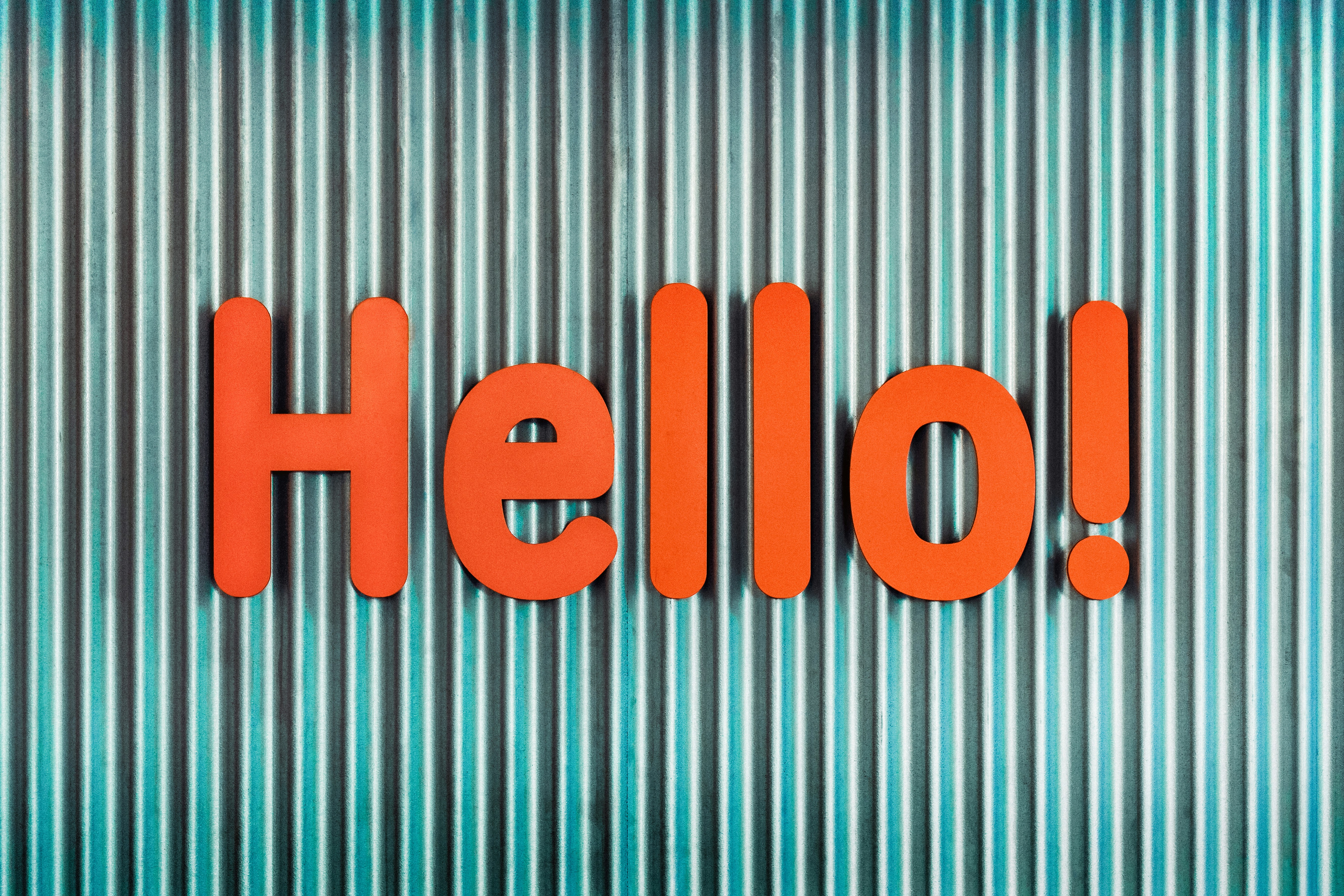 Bold orange hello! text on blue striped background