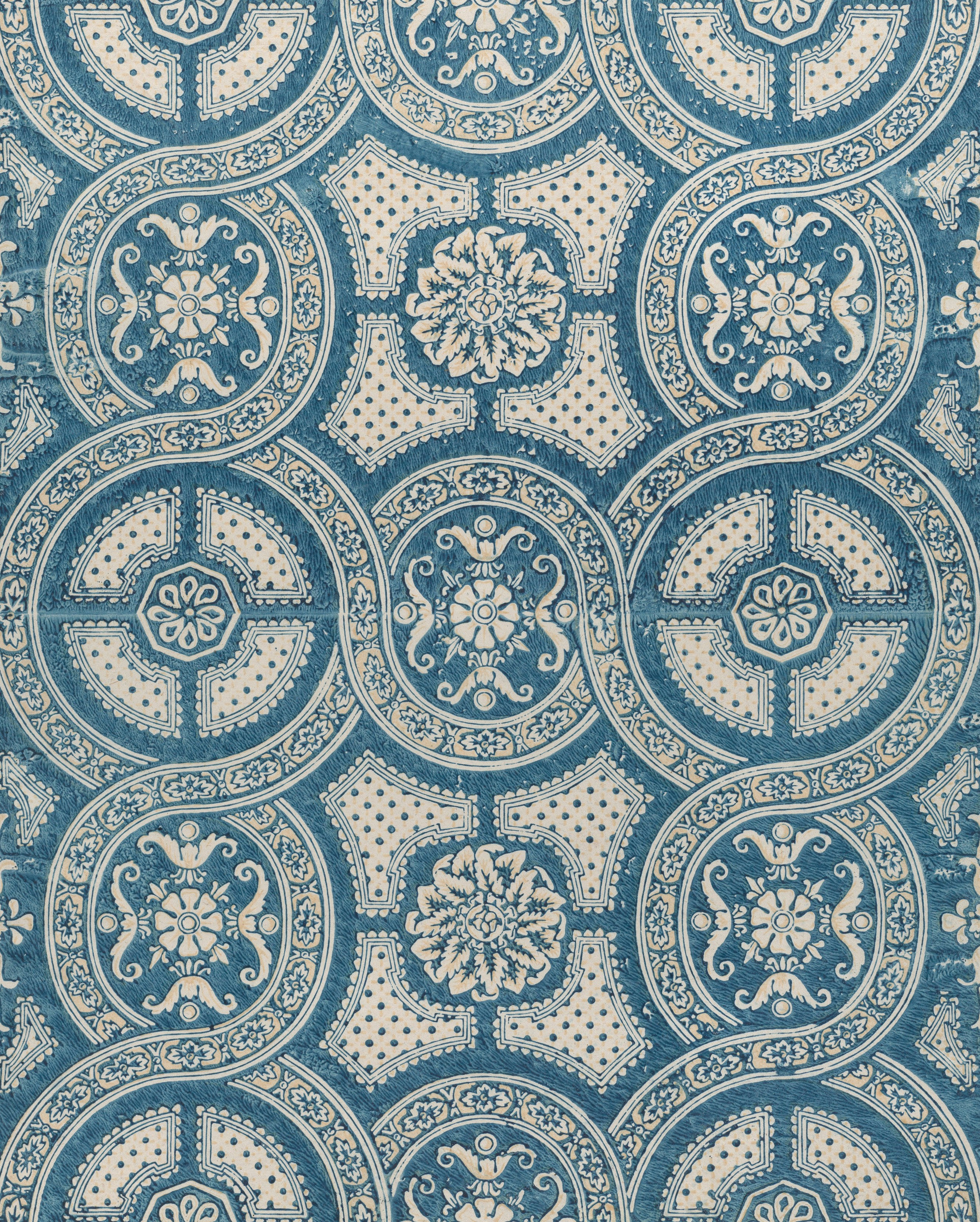 Intricate blue and white circular pattern with floral motifs