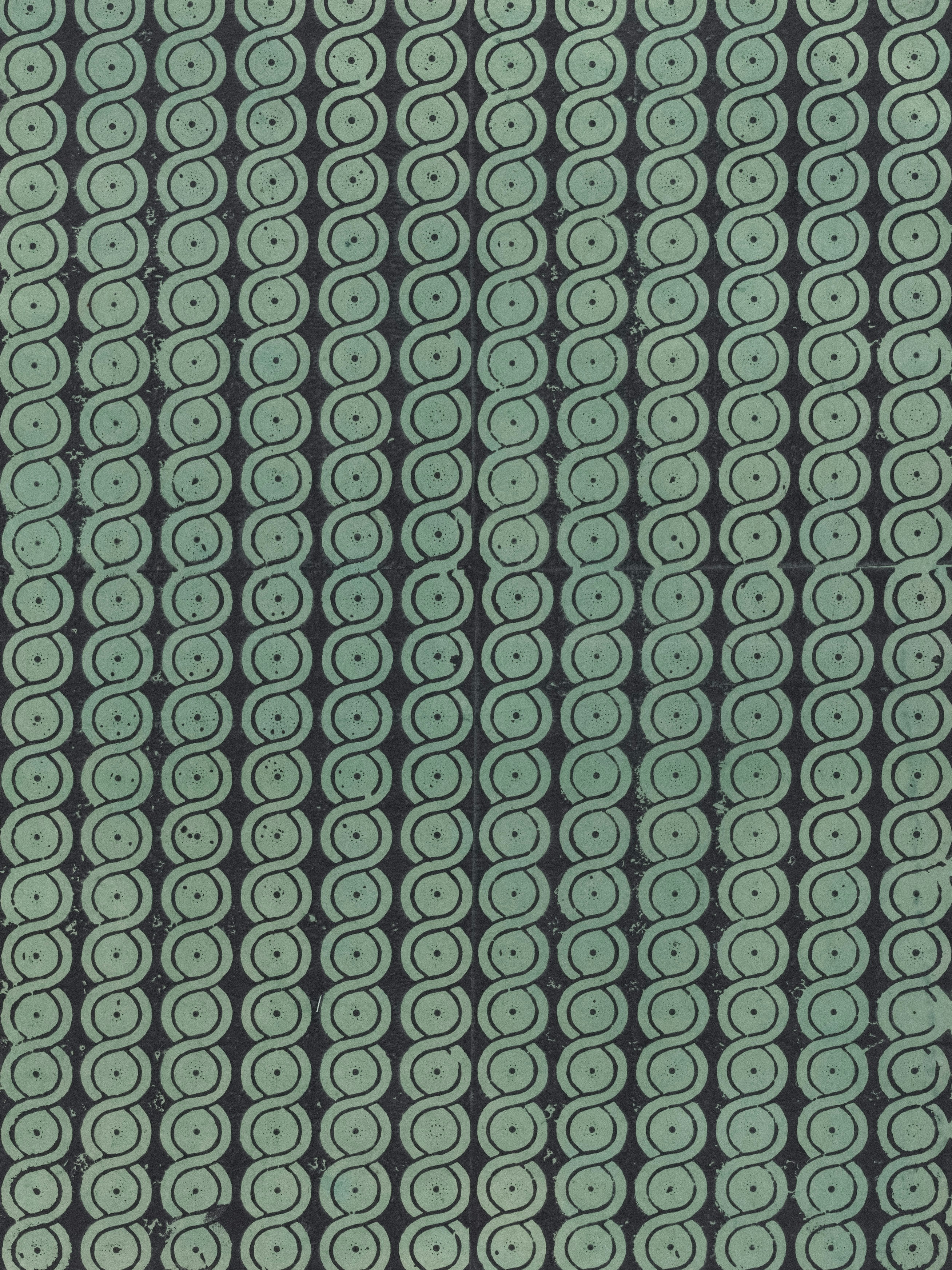 Photo of Repeating teal green spiral pattern on a dark background. by The Metropolitan Museum of Art