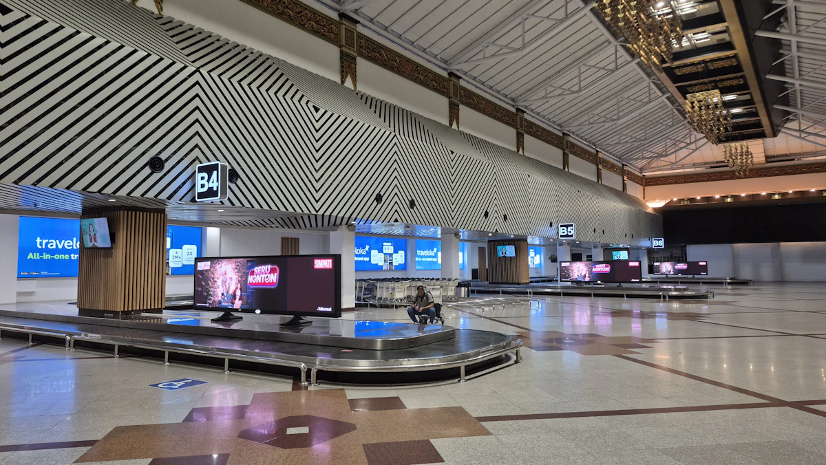 Passengers queueing at an airport security checkpoint