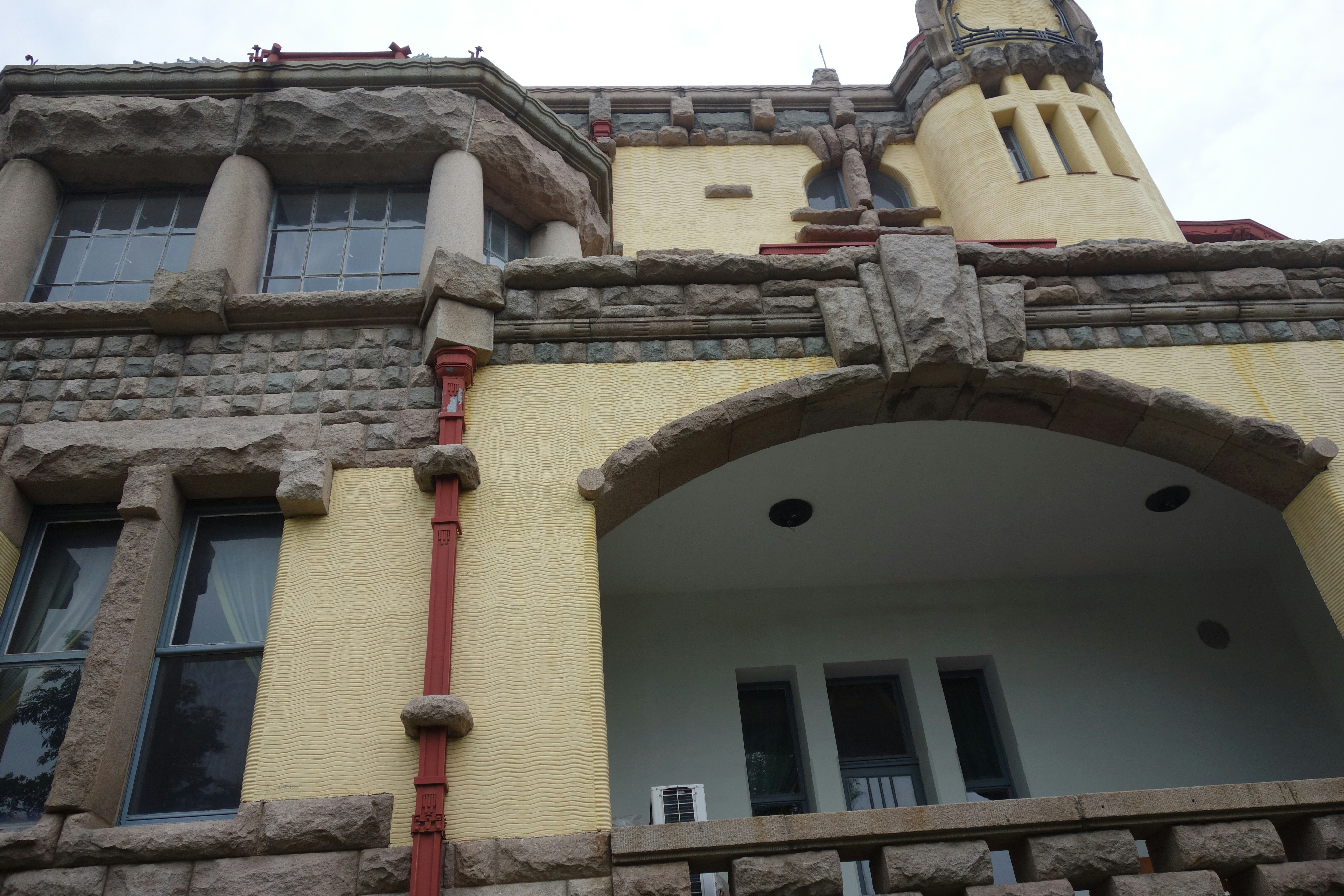 Ornate historic building with yellow walls and stone accents.