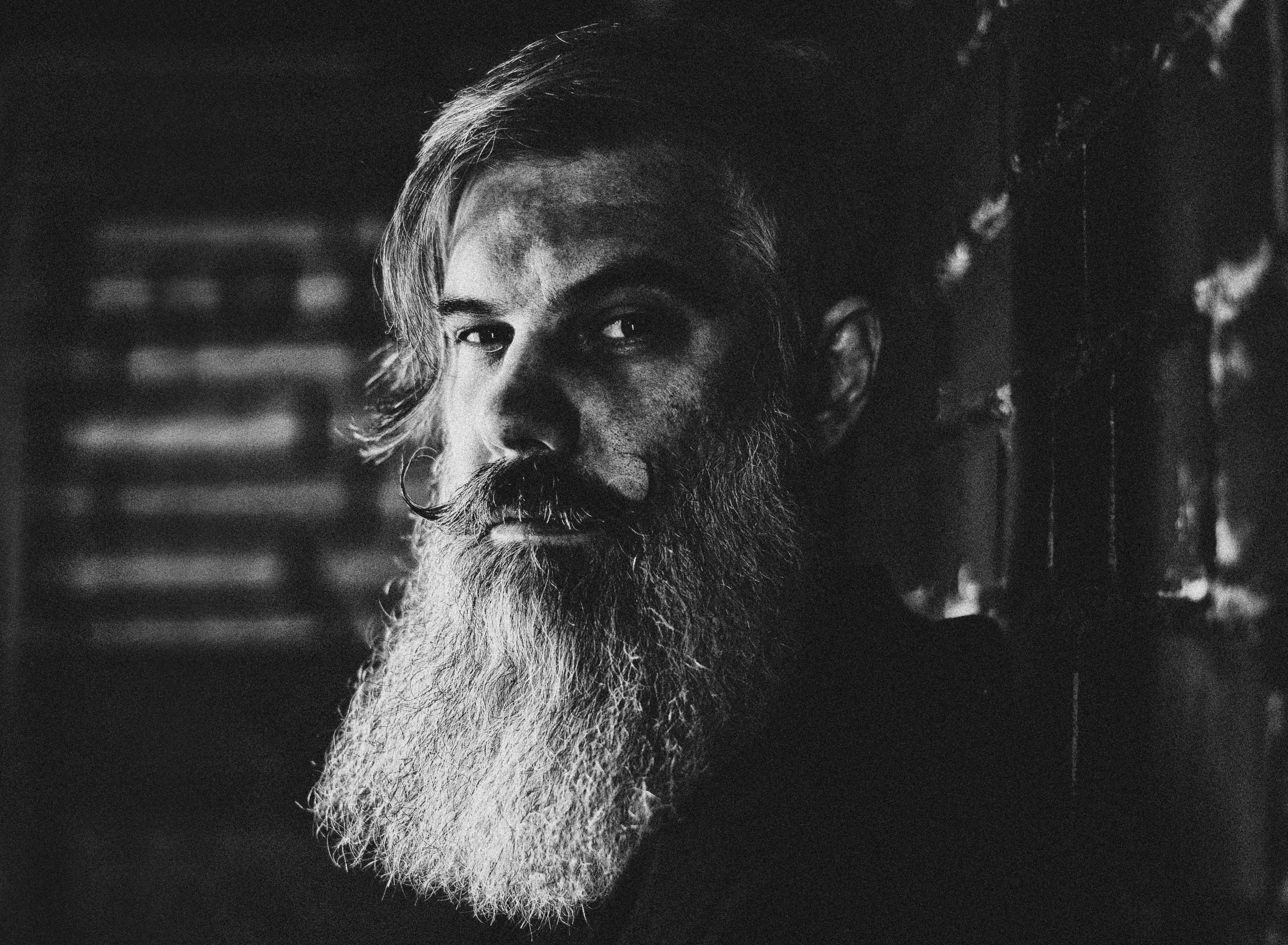Black and white portrait of a bearded man with mustache.