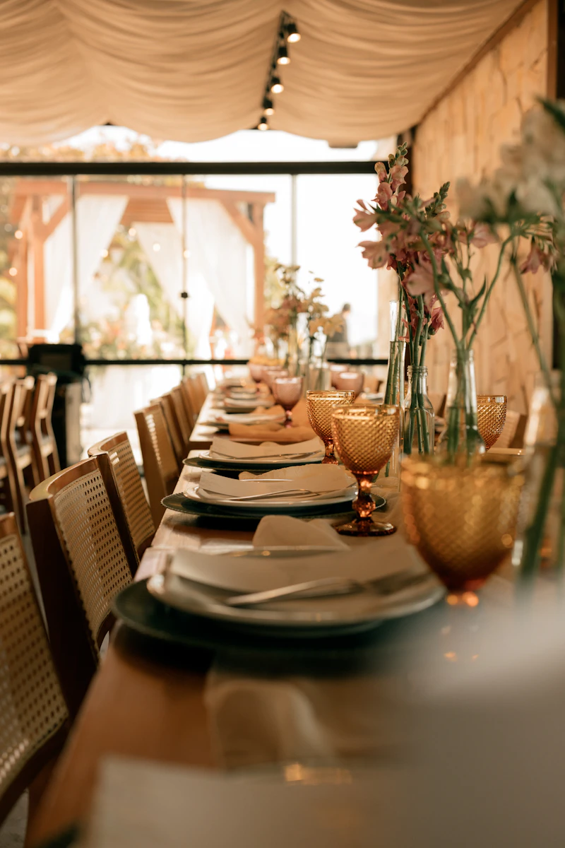 A long banquet table set with floral centrepieces