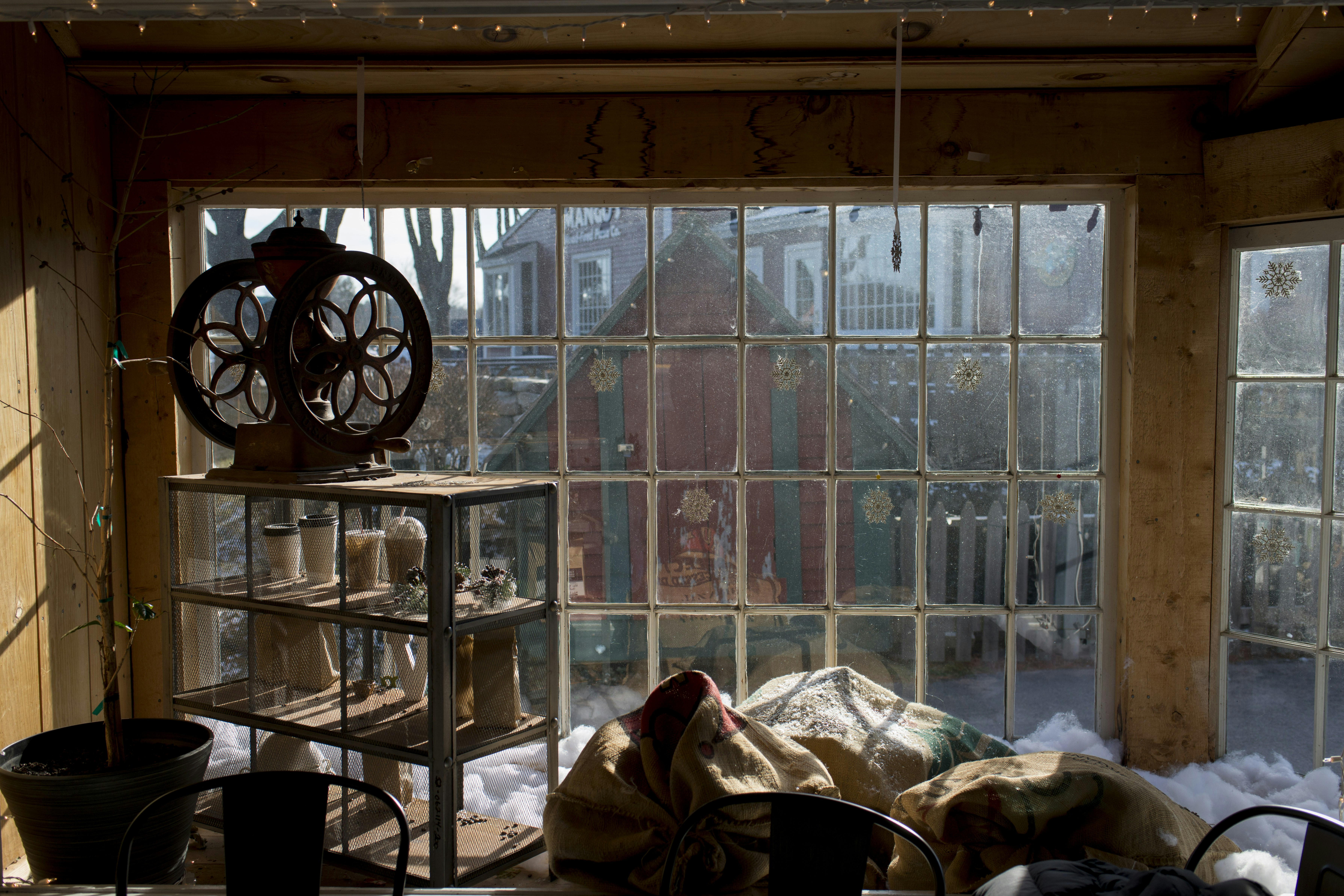 Old machine and burlap sacks by a sunlit window