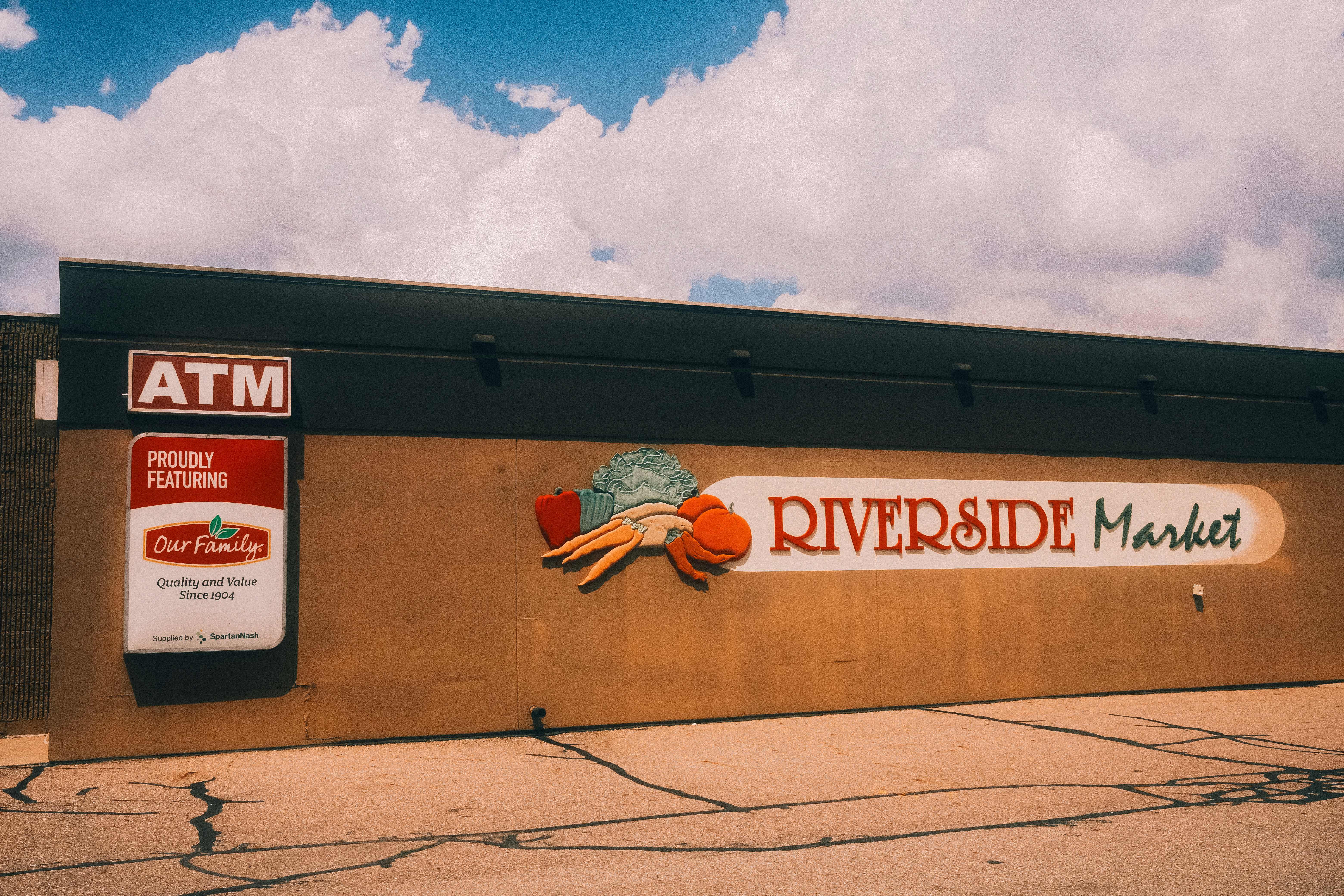 Riverside market building with an atm and food stamp sign.