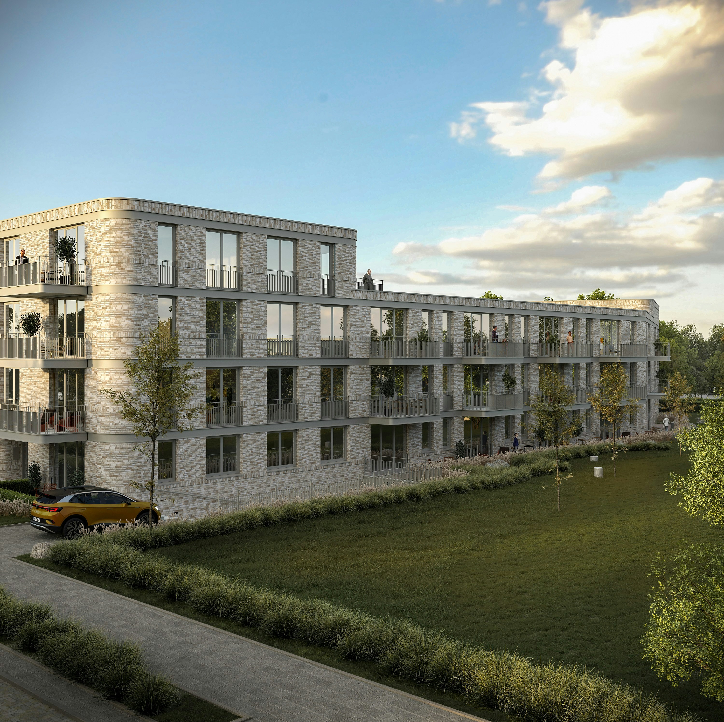 Contemporary brick apartment building with balconies and green space.