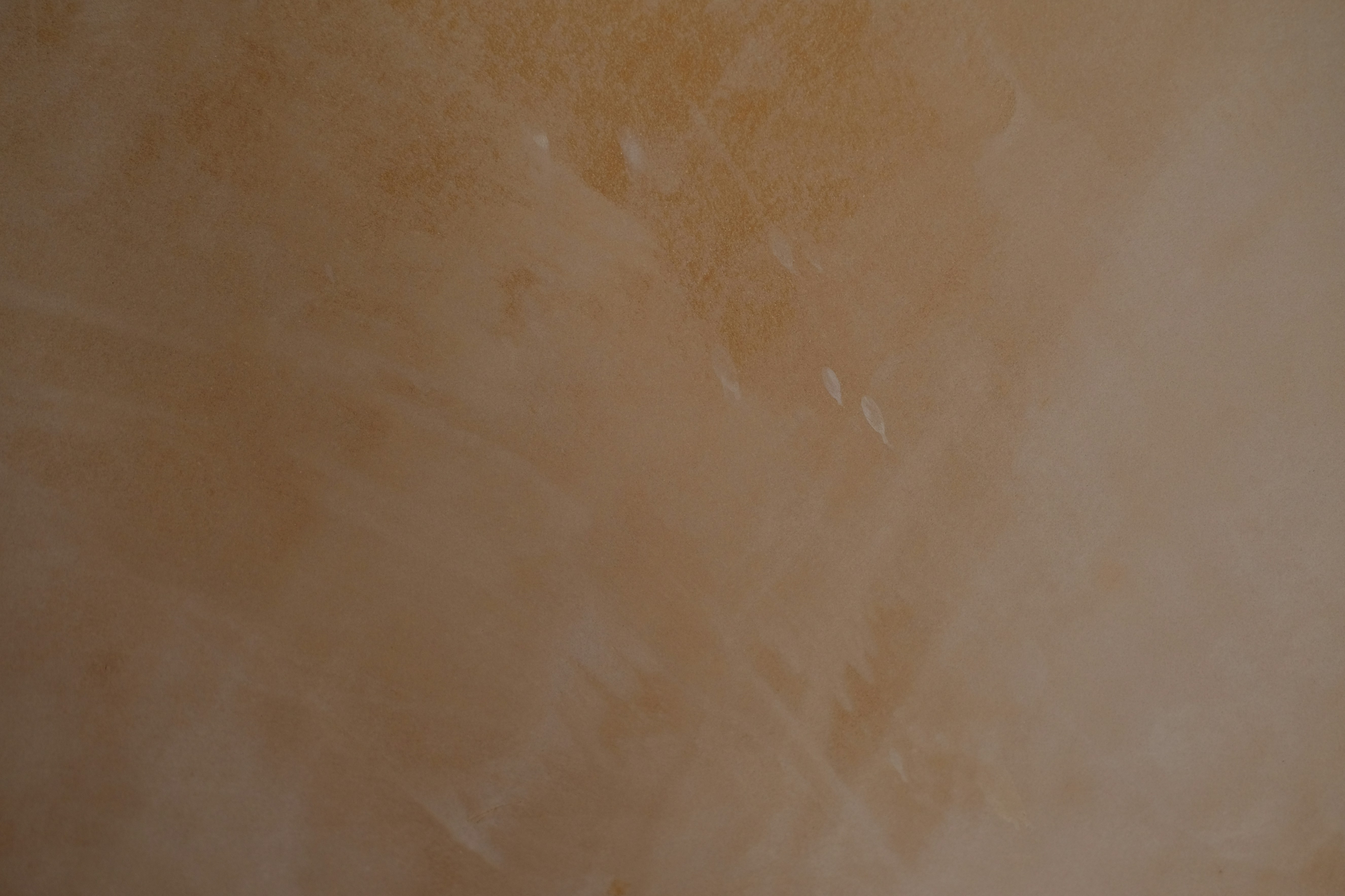 A textured light brown background with subtle white streaks
