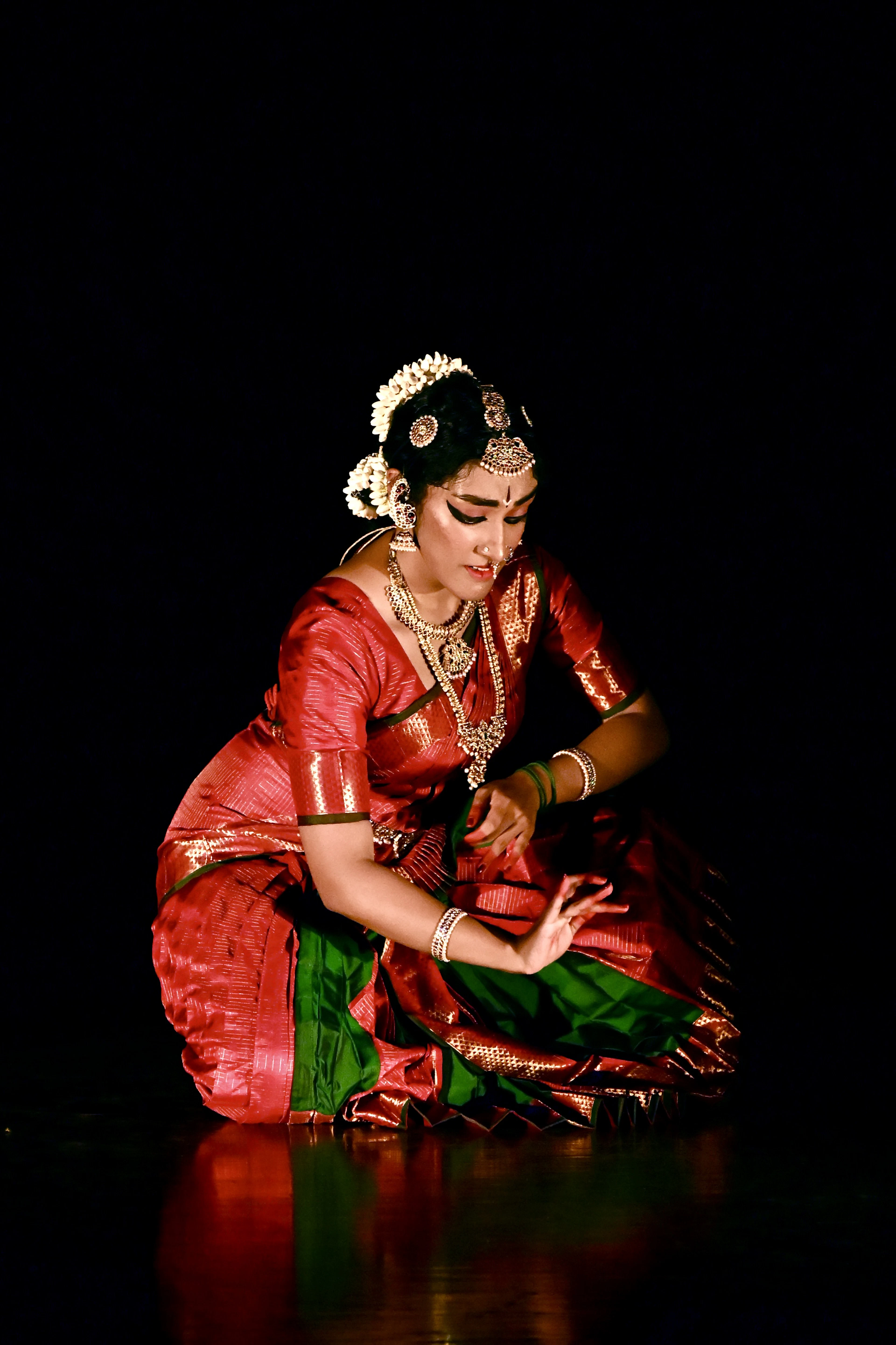 A classical dancer in red and green costume