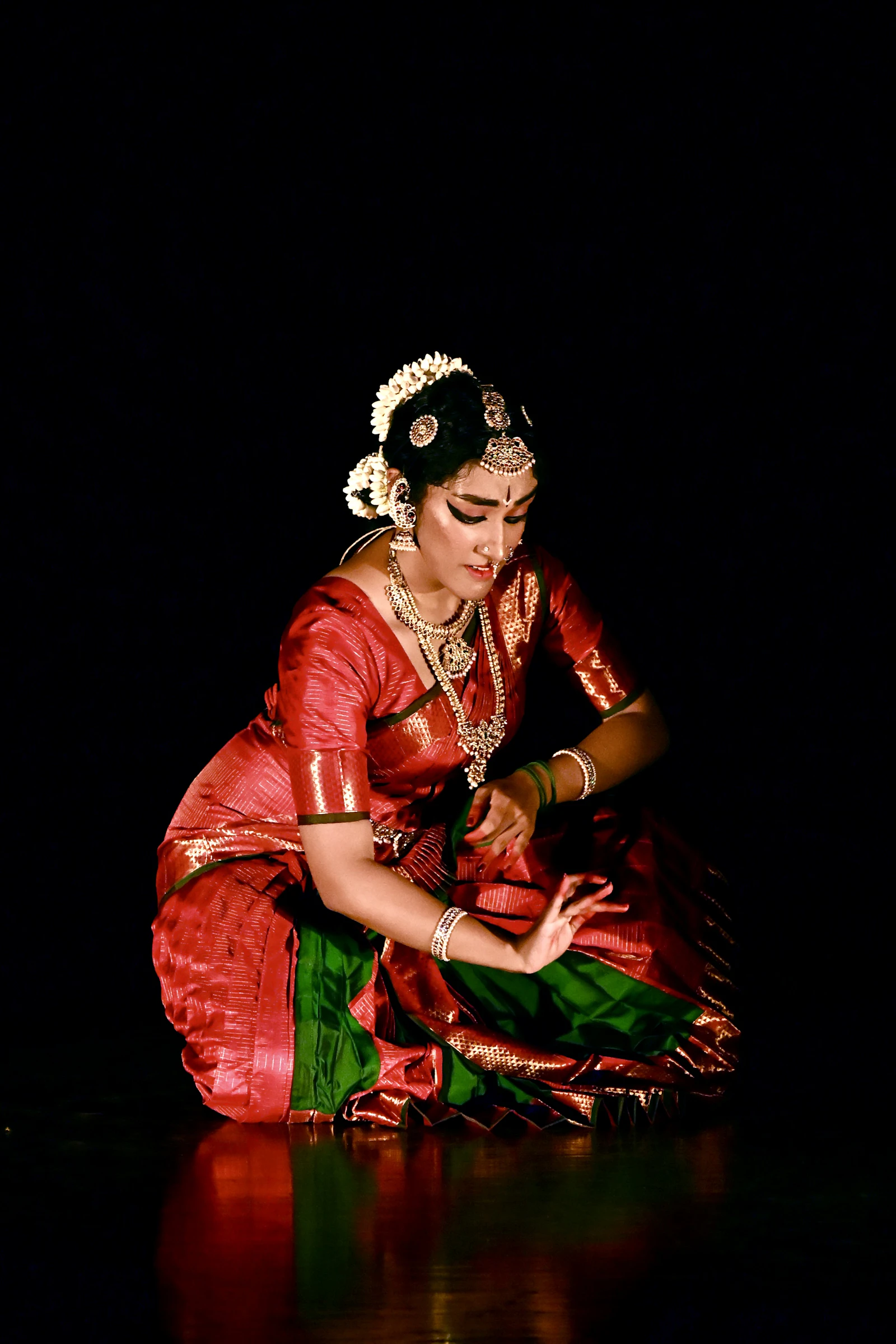 Kathak soloist in red against black