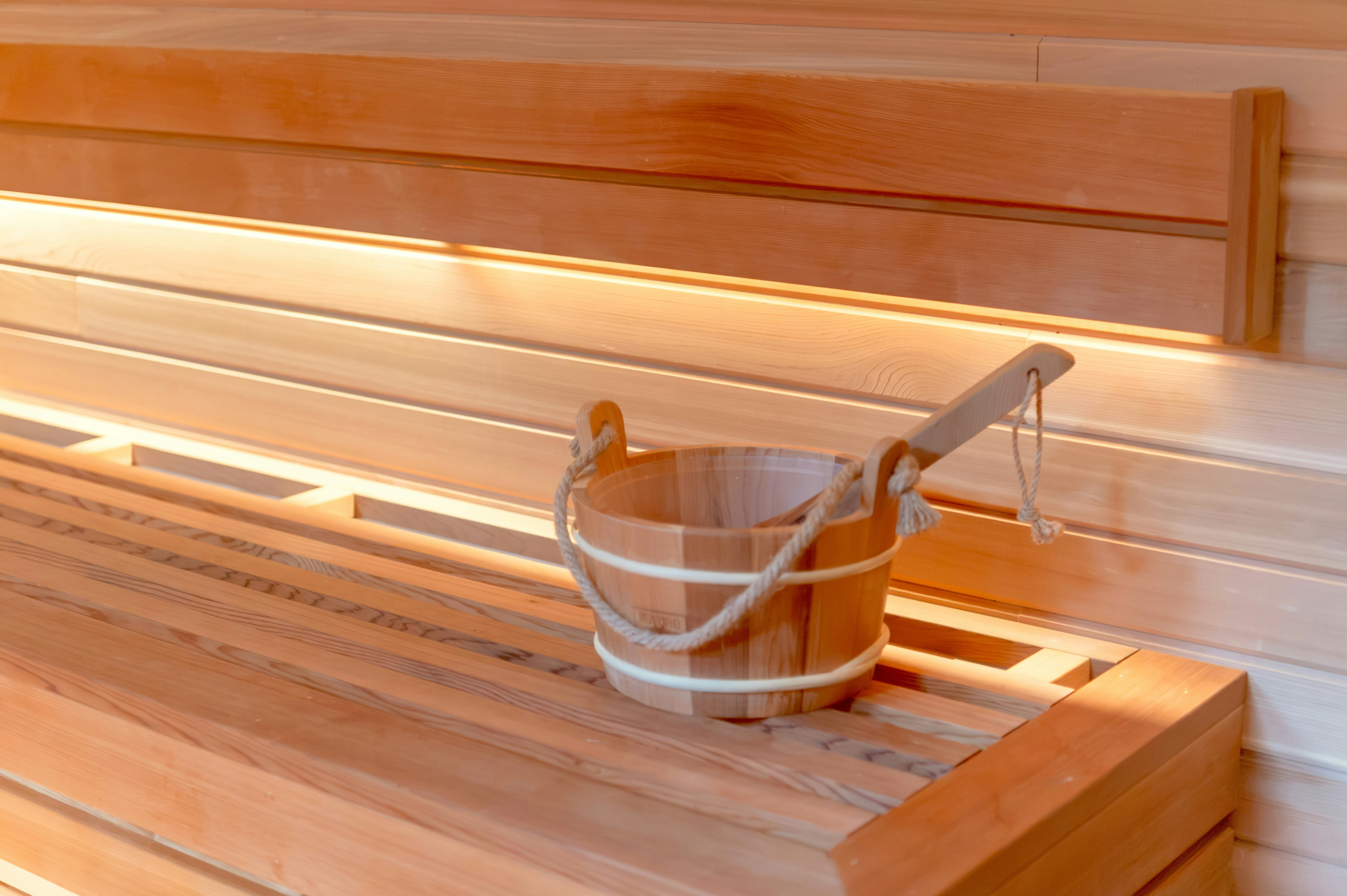 Wooden sauna interior with bucket and ladle