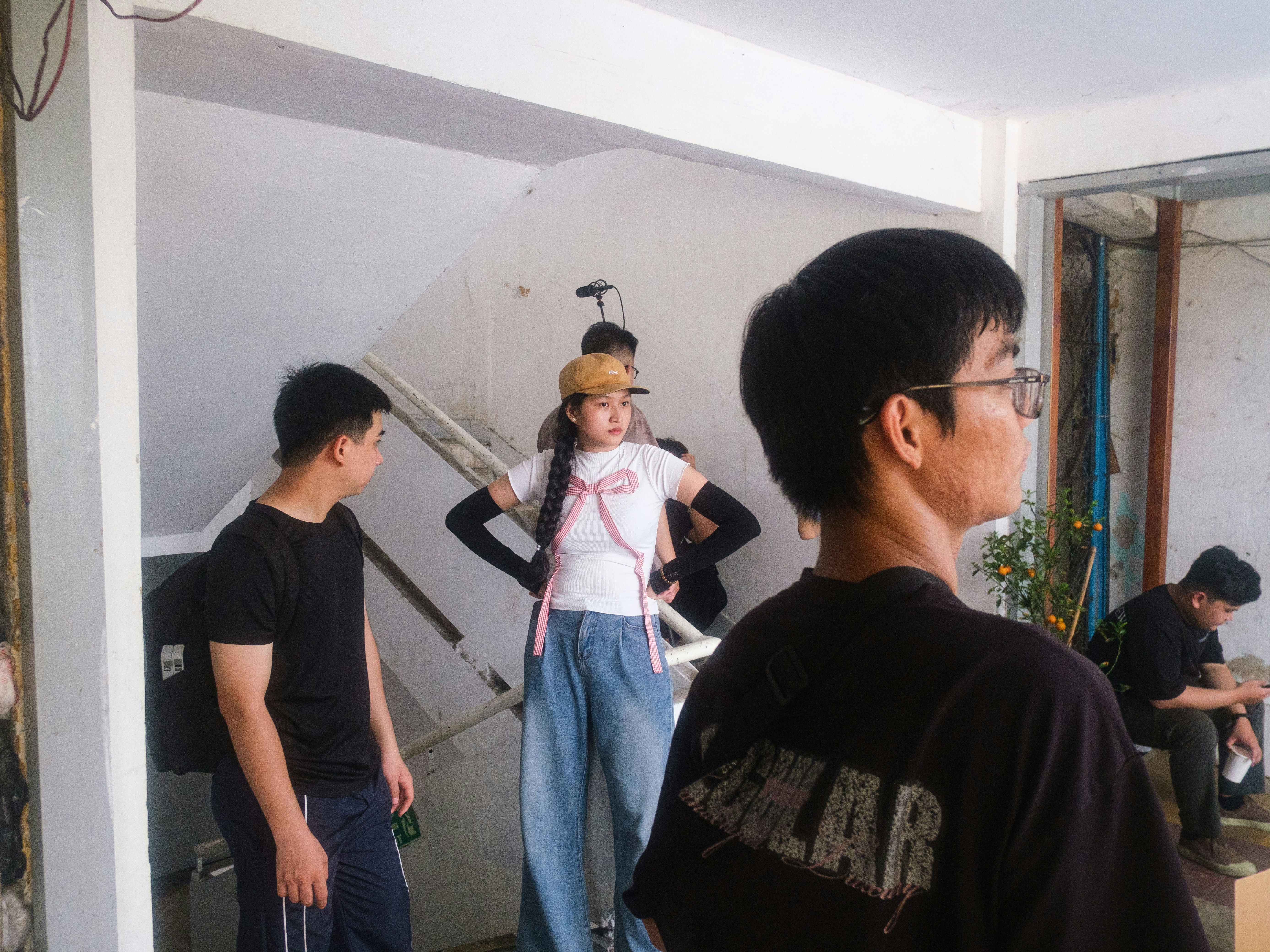 A woman and others stand in a building's stairwell
