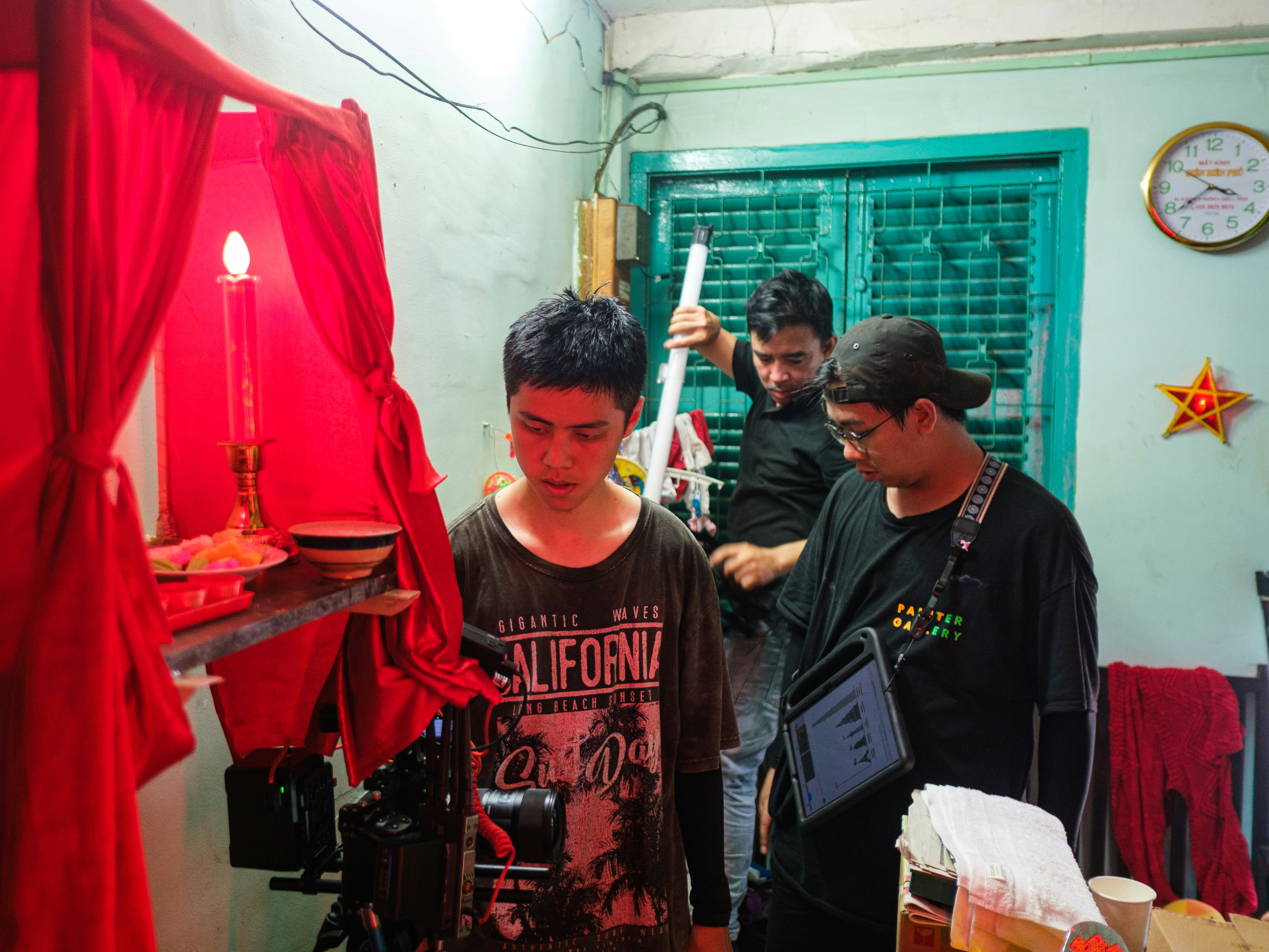 Crew members filming a scene with a red candle