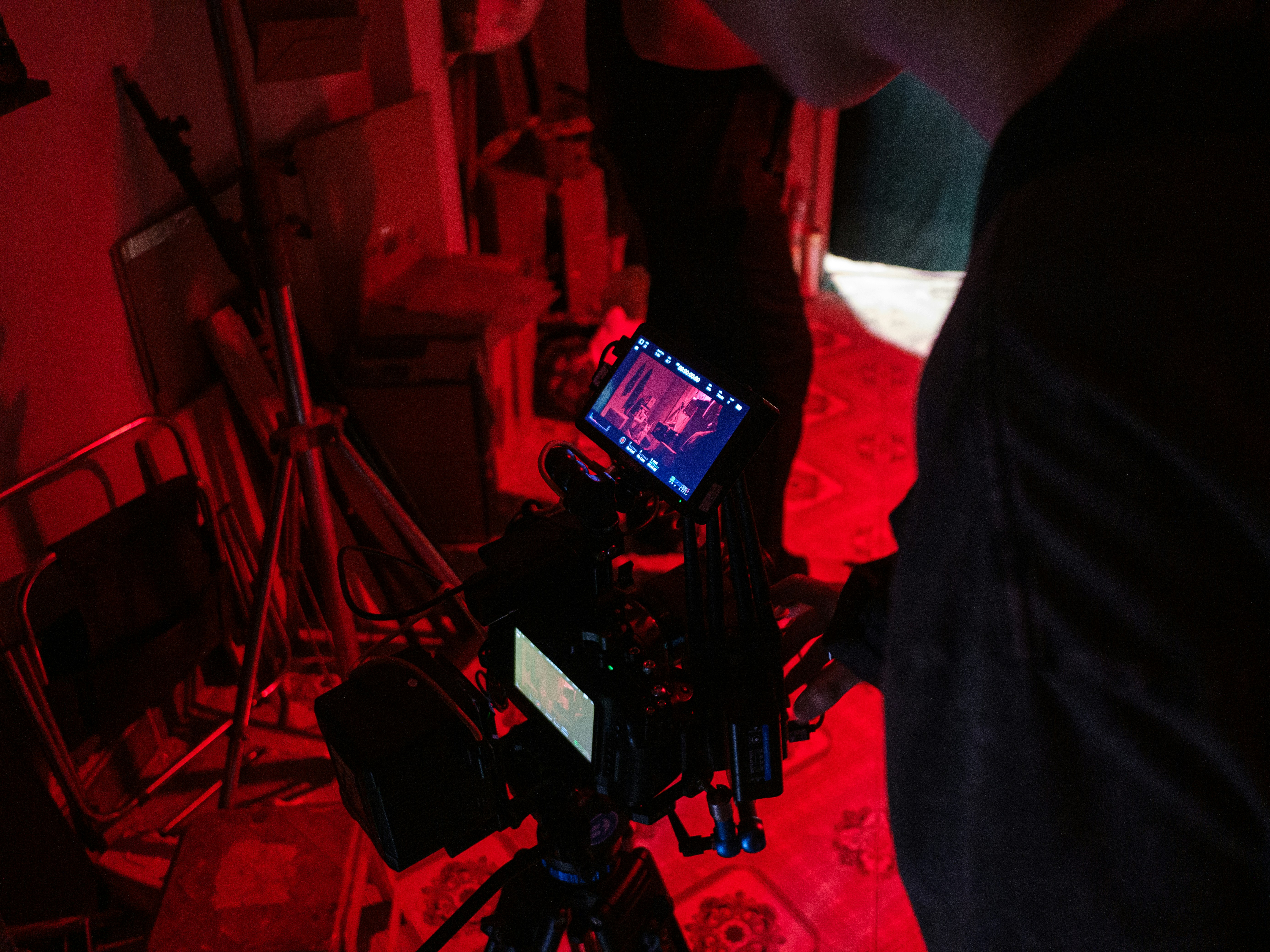 Operator views camera monitor in red light.