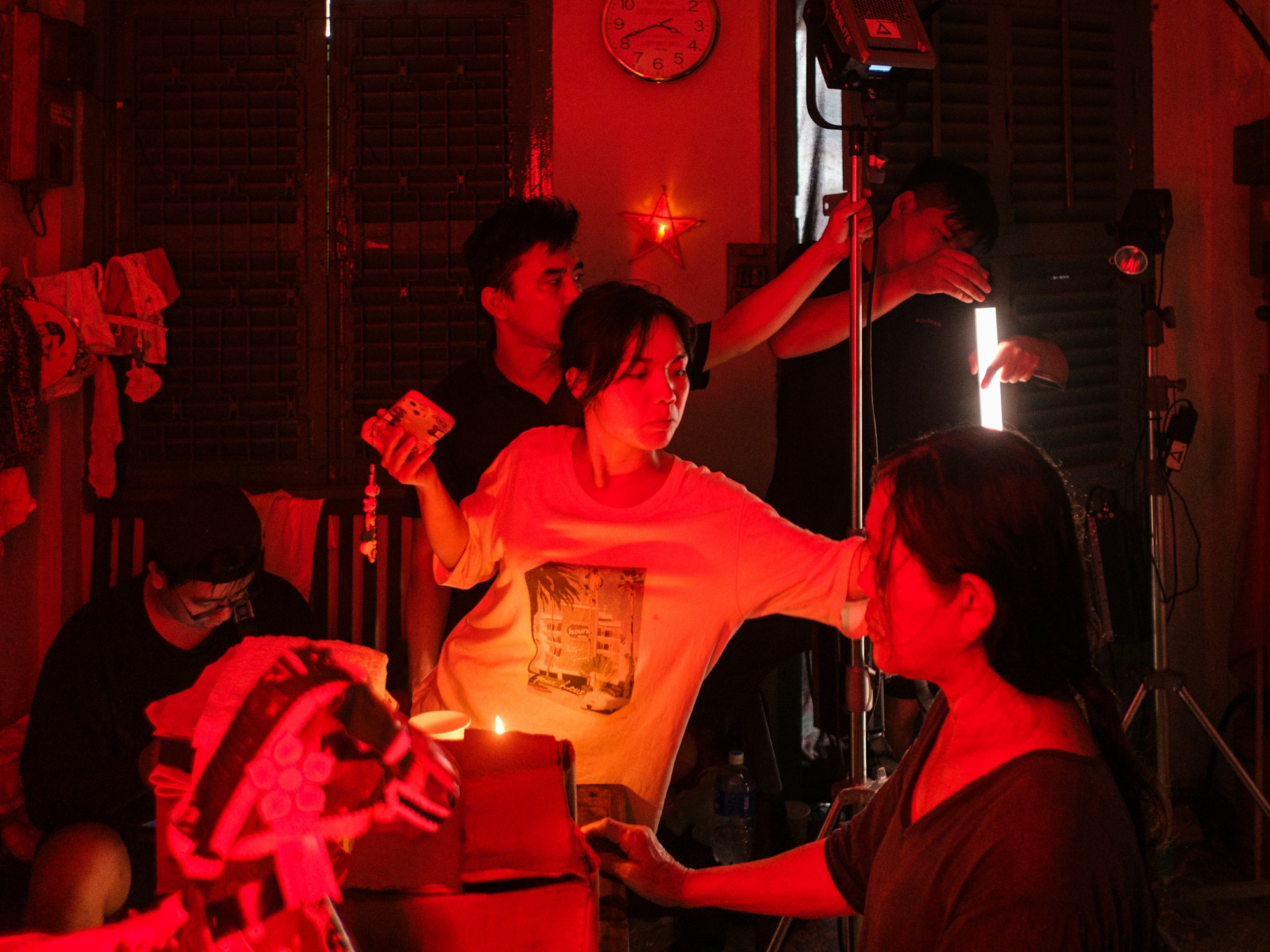 Filmmakers working on set under dramatic red lighting, placeholder production image