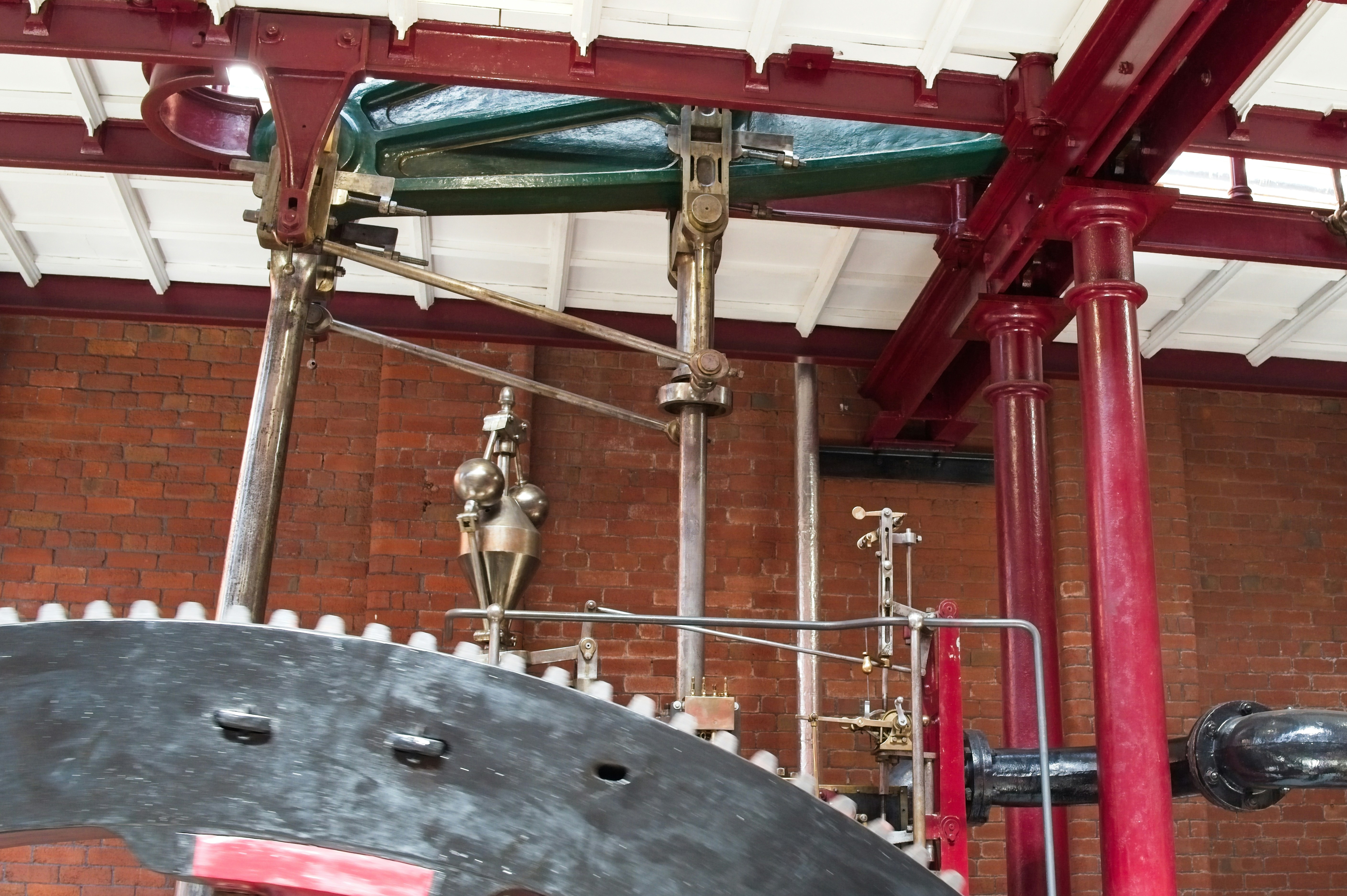 Intricate mechanical components of an old steam engine.