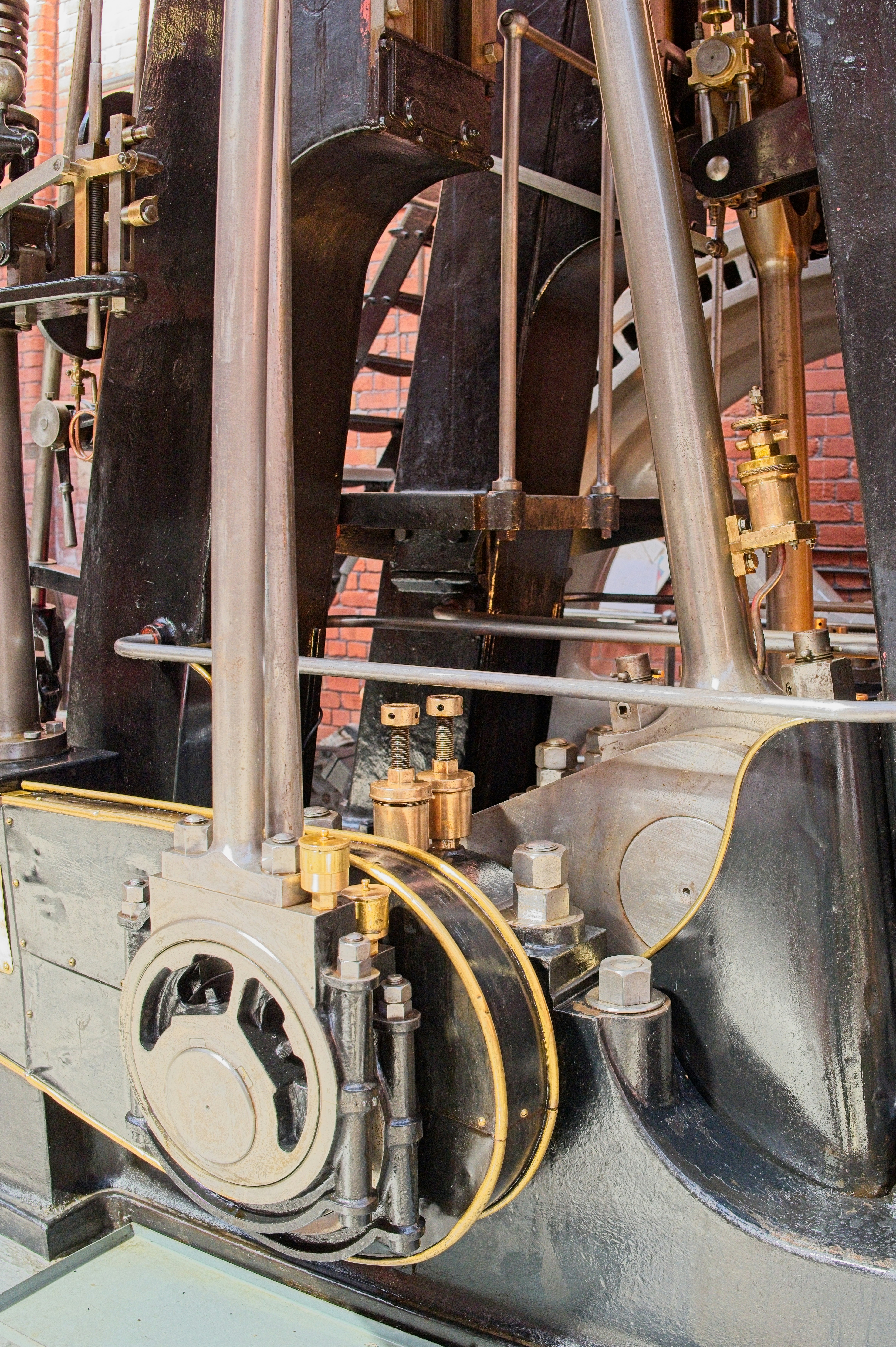 Vintage industrial steam engine with brass and metal components.