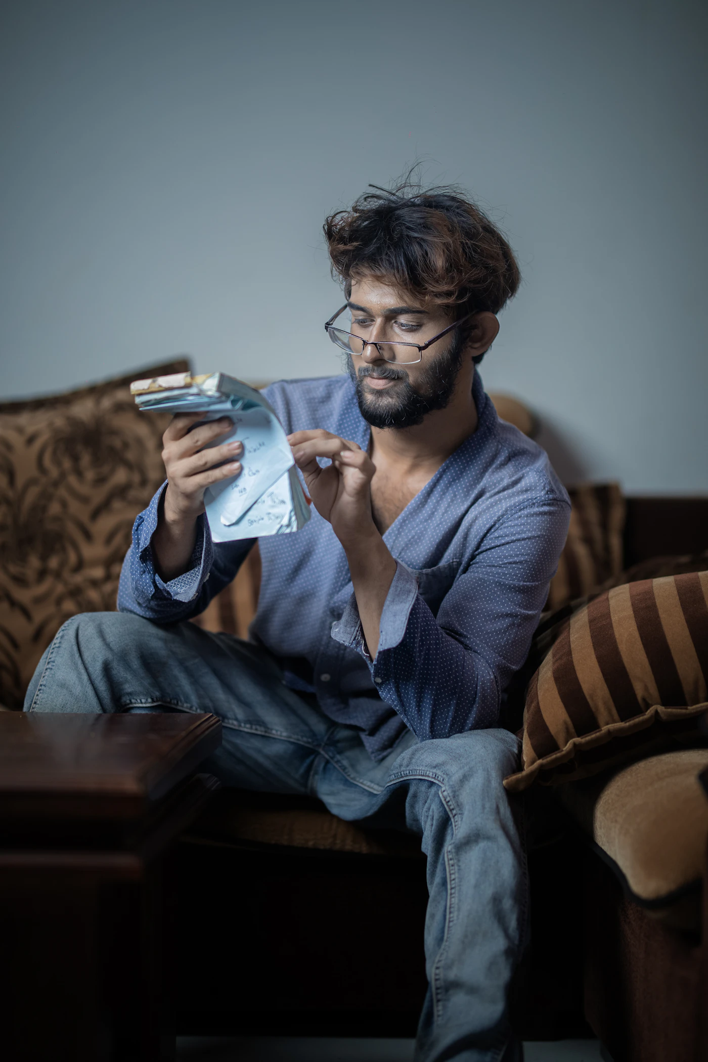 Man reviewing paperwork while sitting on a couch