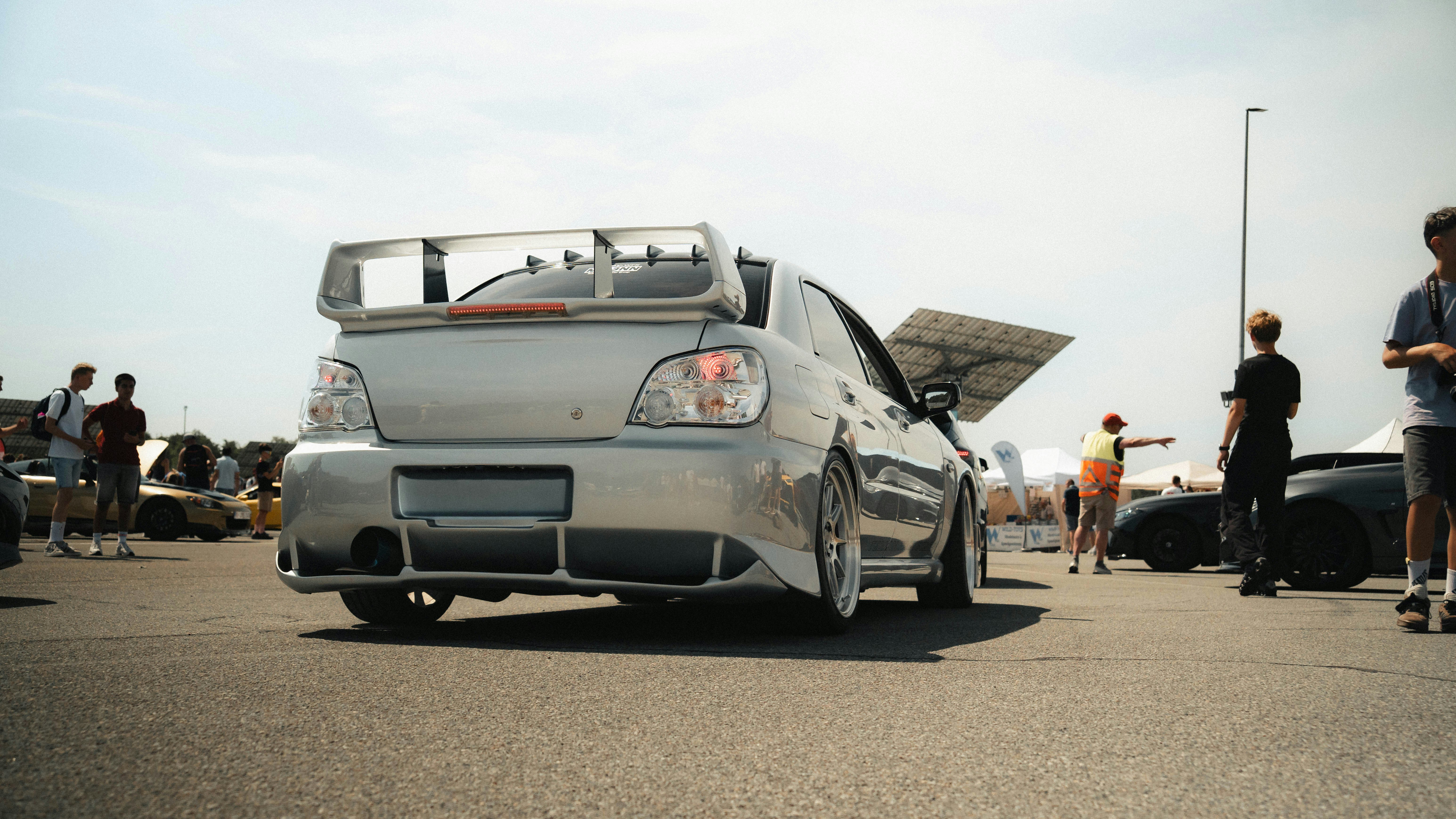 Cars Silver Modified Car With Open Trunk At Outdoor Event. 4K Wallpaper #3501