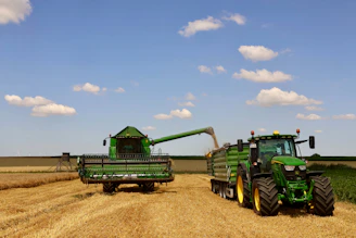 Combine harvester unloads grain into tractor trailer