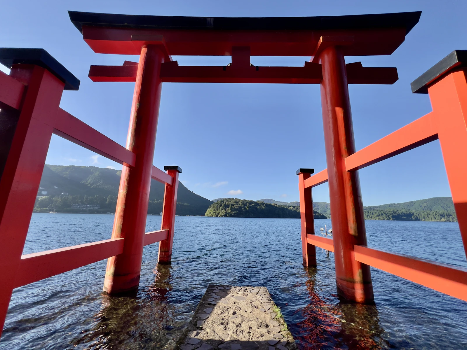 Hakone Shrine's red torii gate on the shore of Lake Ashi