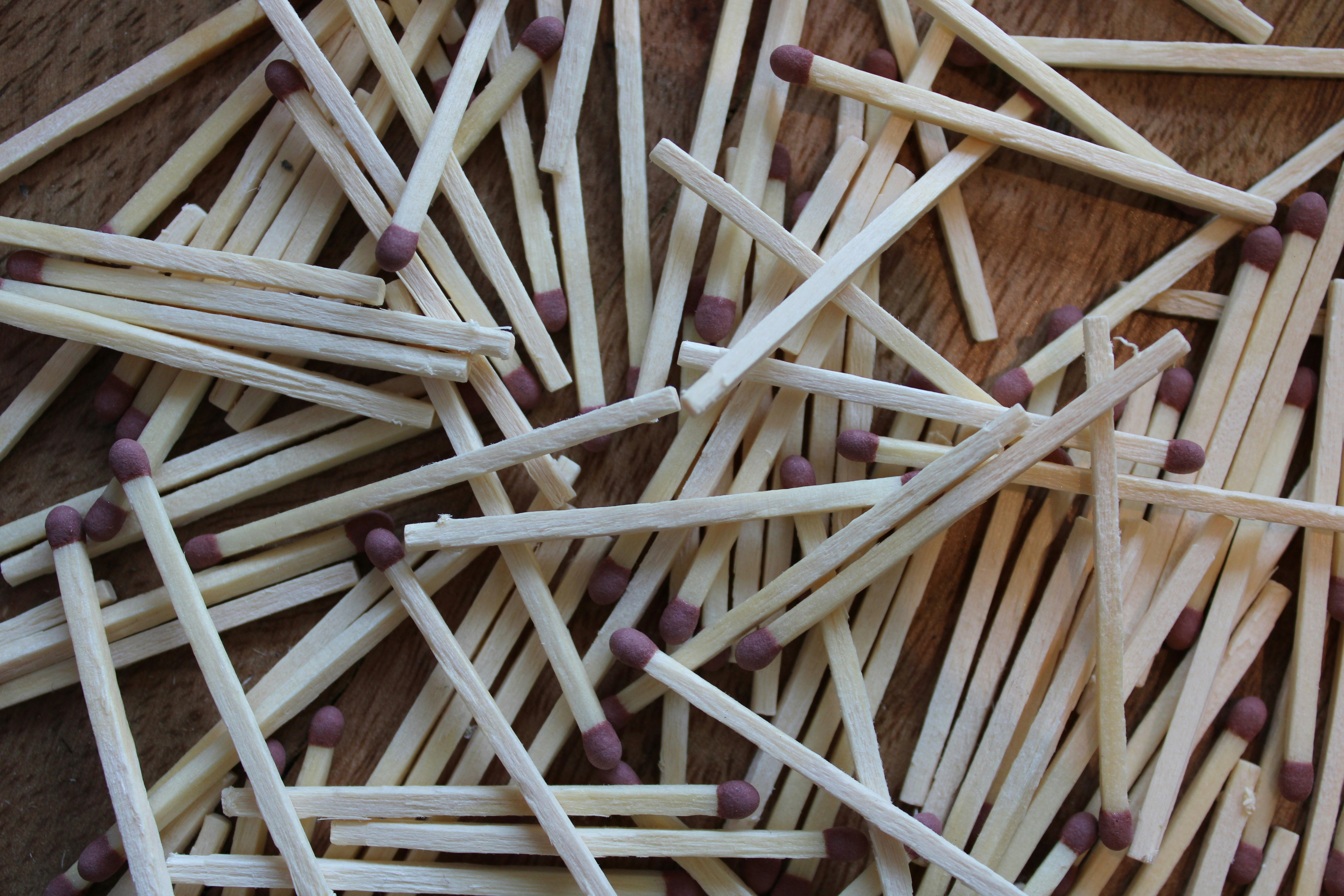 Scattered wooden matches with brown tips