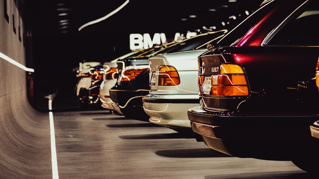 A row of classic BMW cars parked indoors.