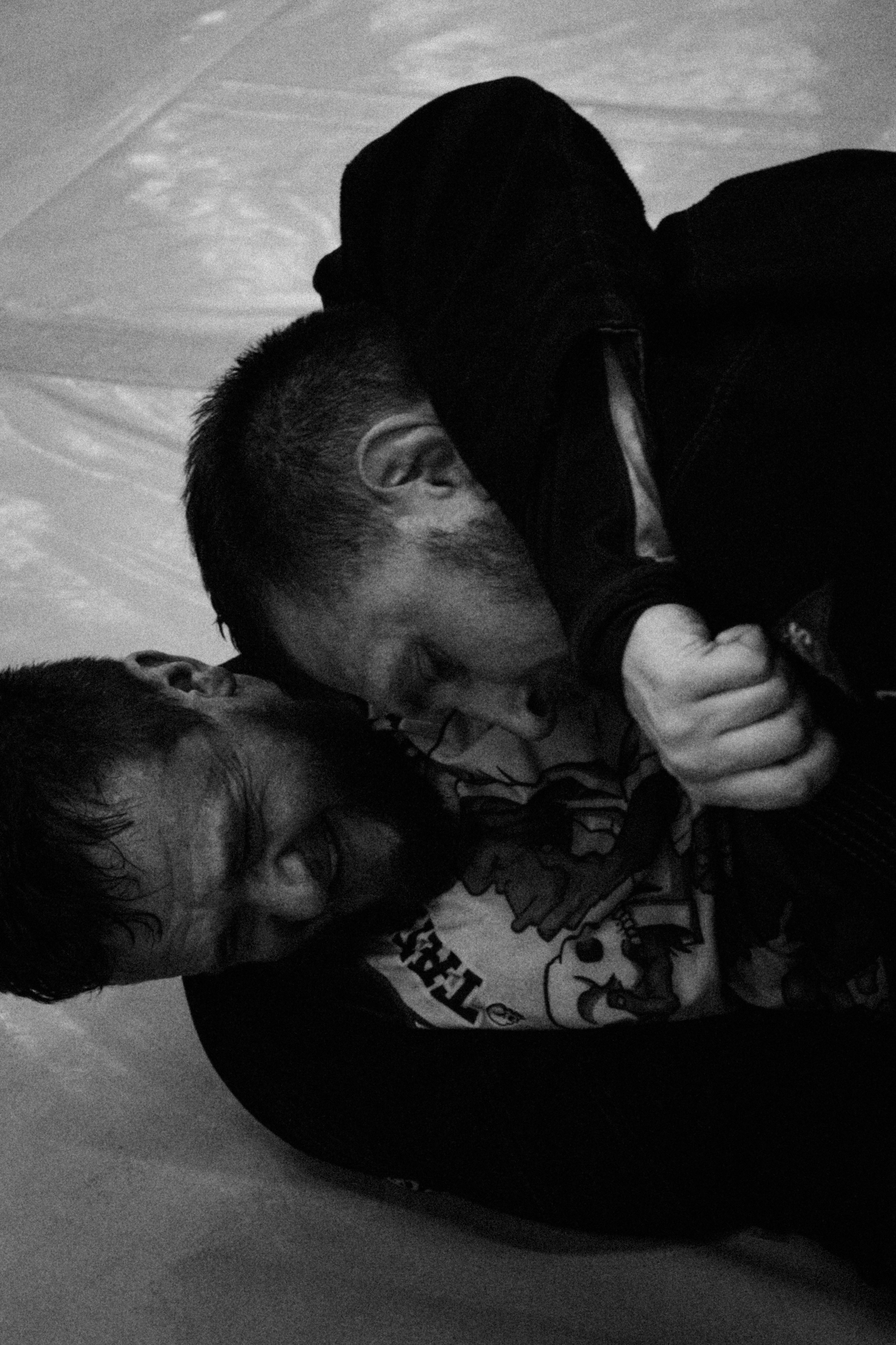 Two men in a headlock during a wrestling match