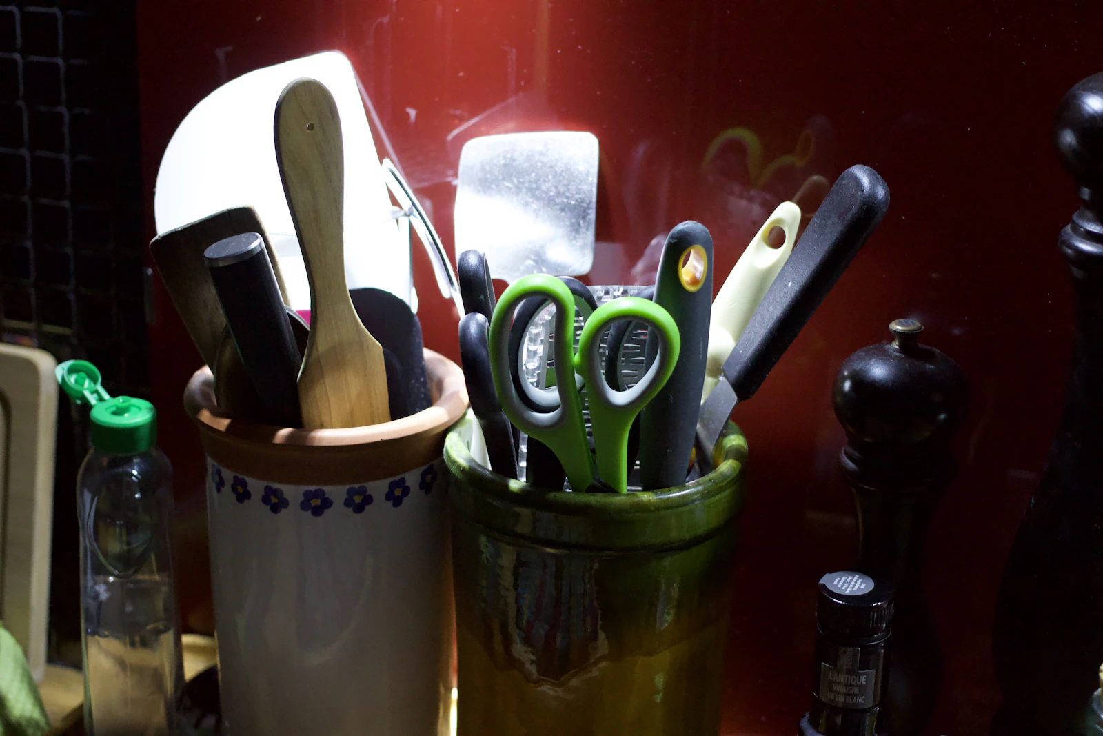 Real kitchen utensils arranged in ceramic containers