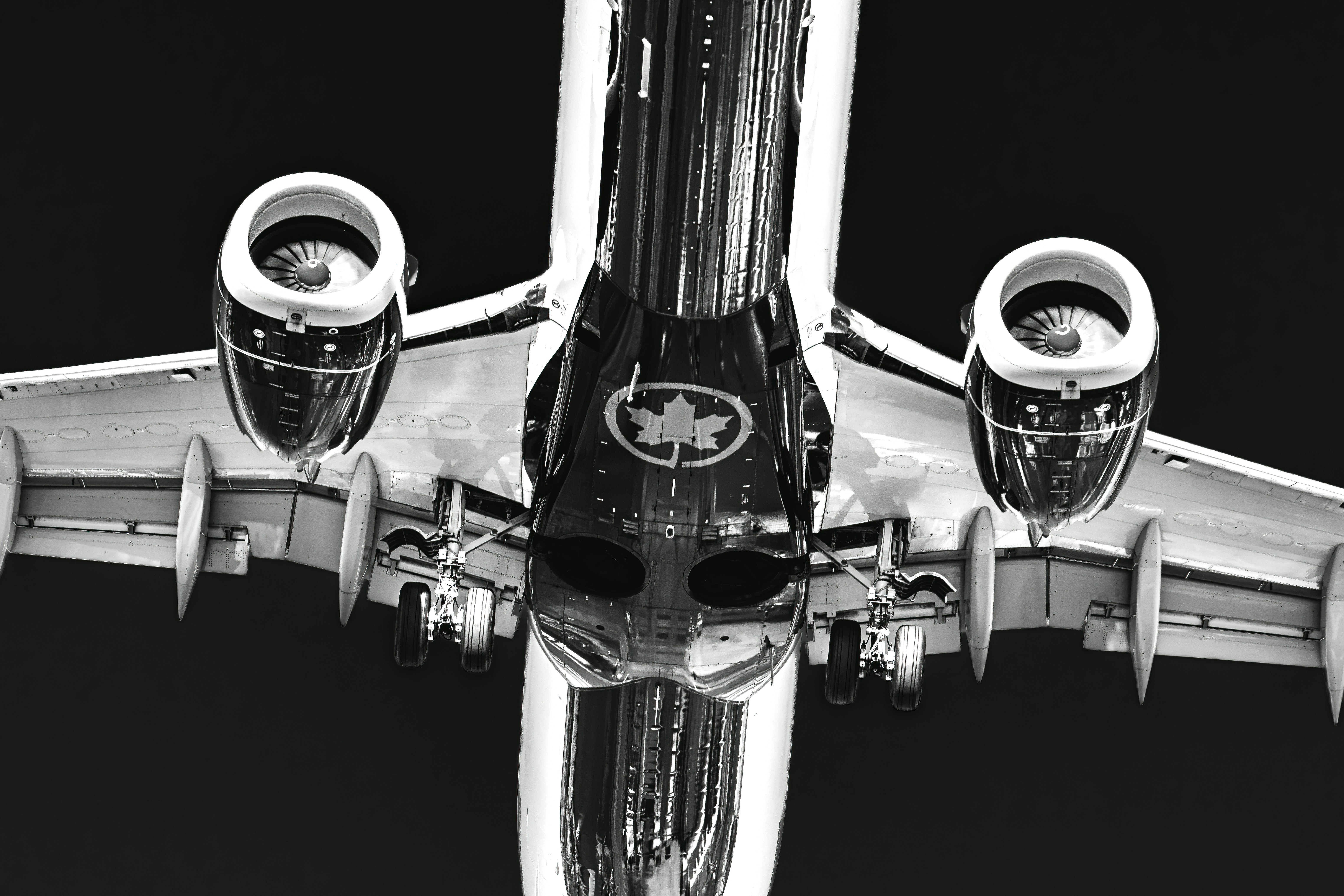 Airplane underside with engines and canadian maple leaf logo.
