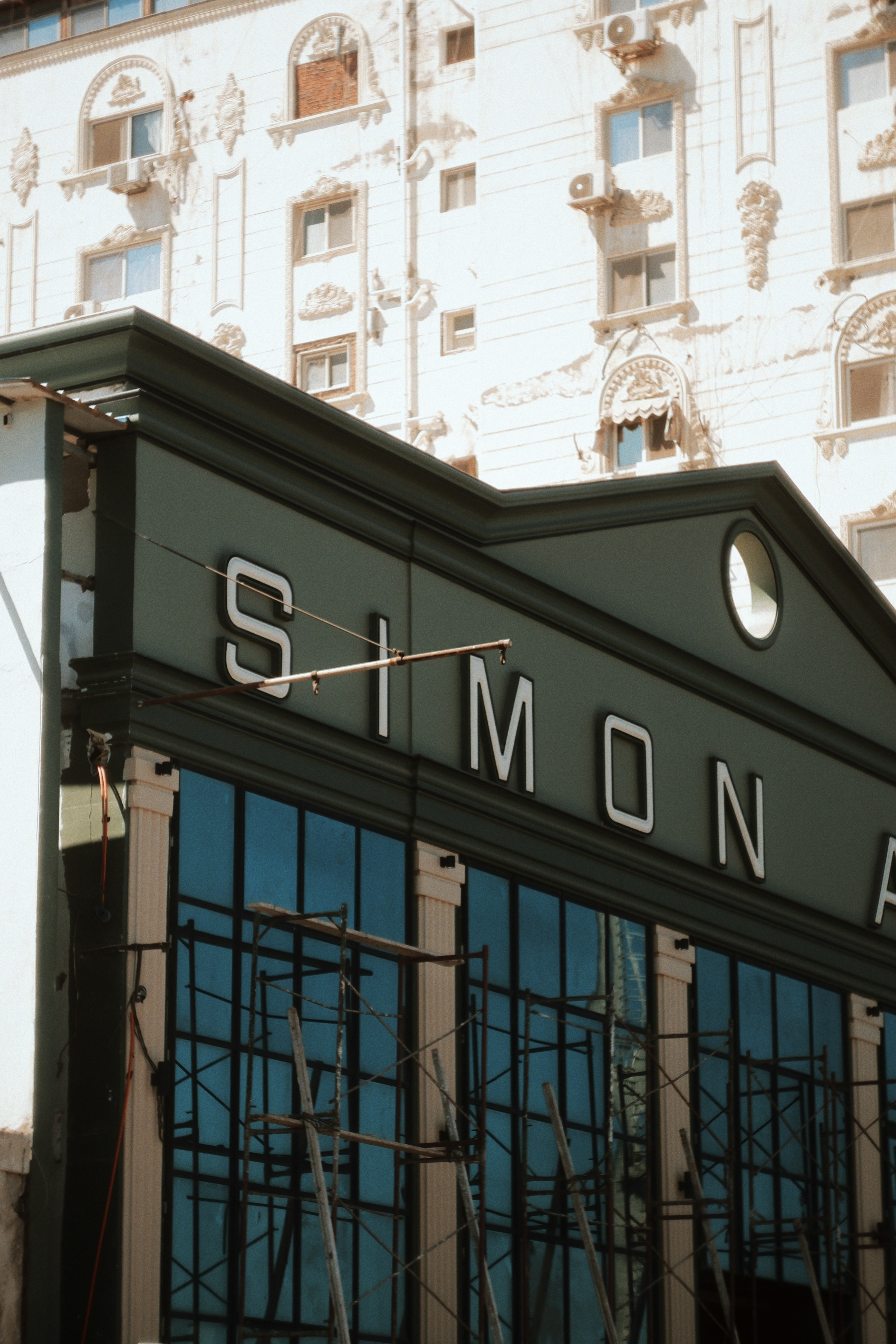 The historic facade of the famous Simon Arzt department store in Port Said, Egypt. The shot captures the iconic green sign and classic European-style architecture, blending vintage heritage with coastal charm.