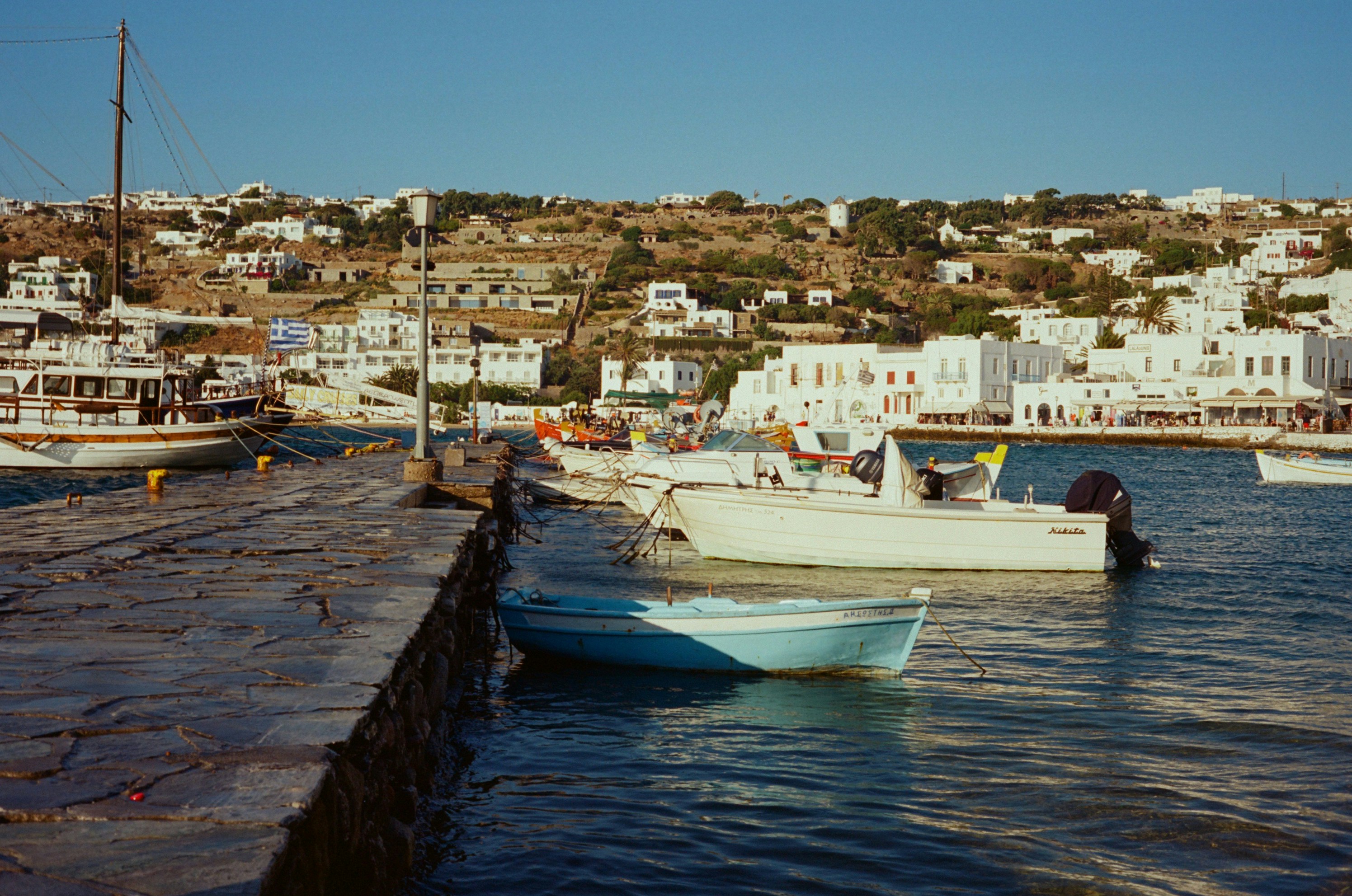 Picturesque harbor scene with boats and a coastal town.