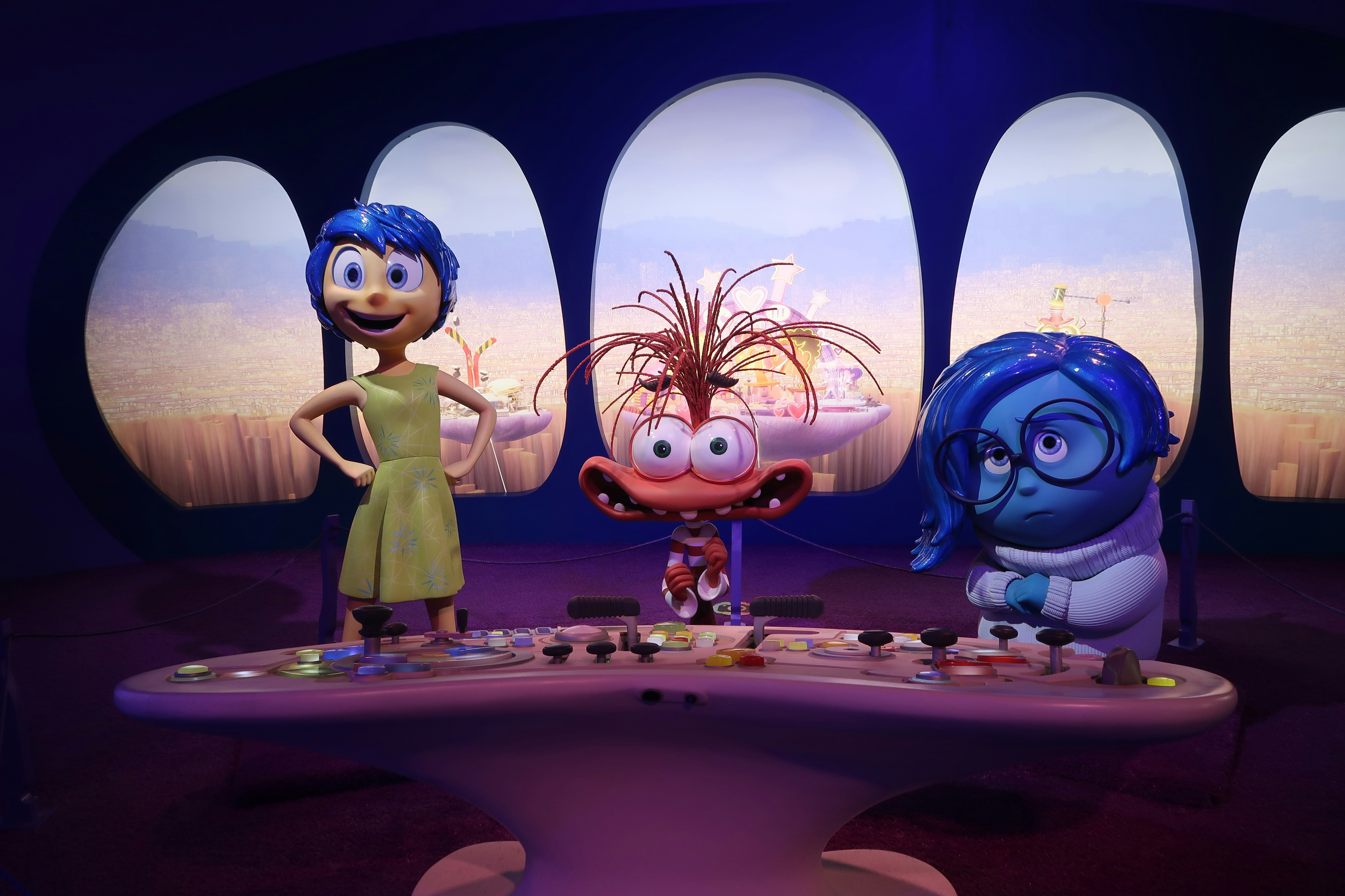 Joy, fear, and sadness characters at a control panel.