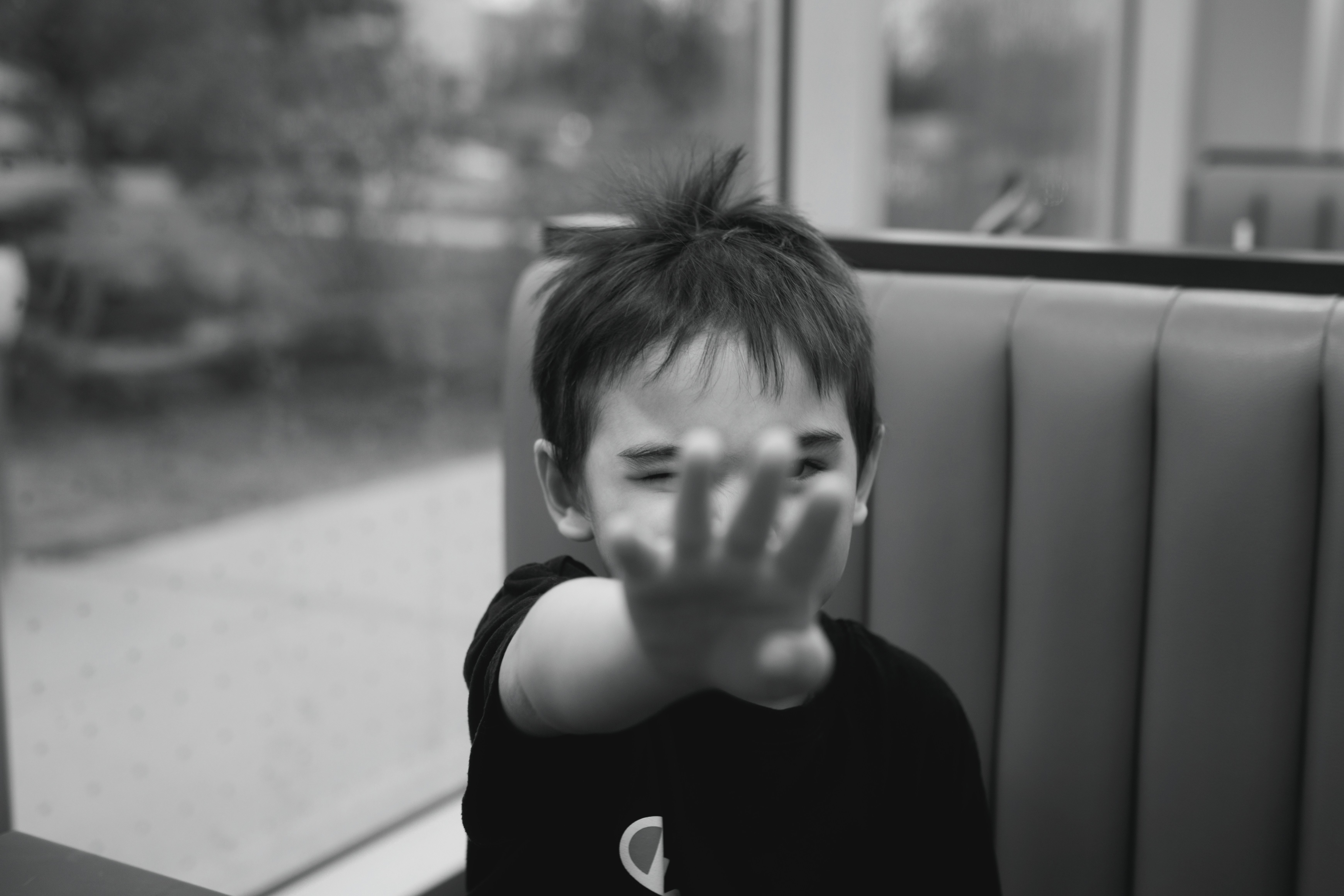 ブースにいる子供が手を差し出して顔を遮っている。