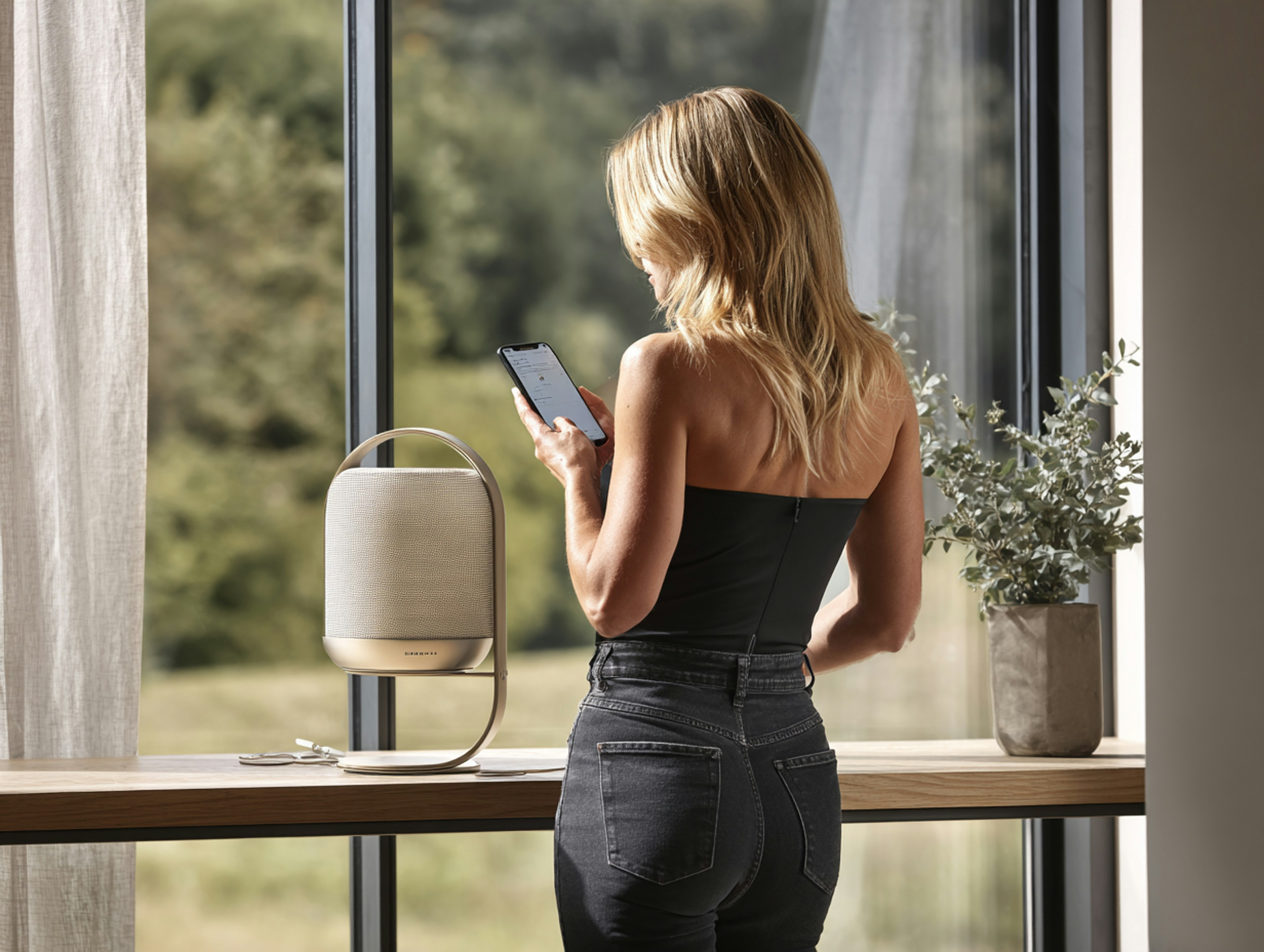Woman using a smartphone by a window