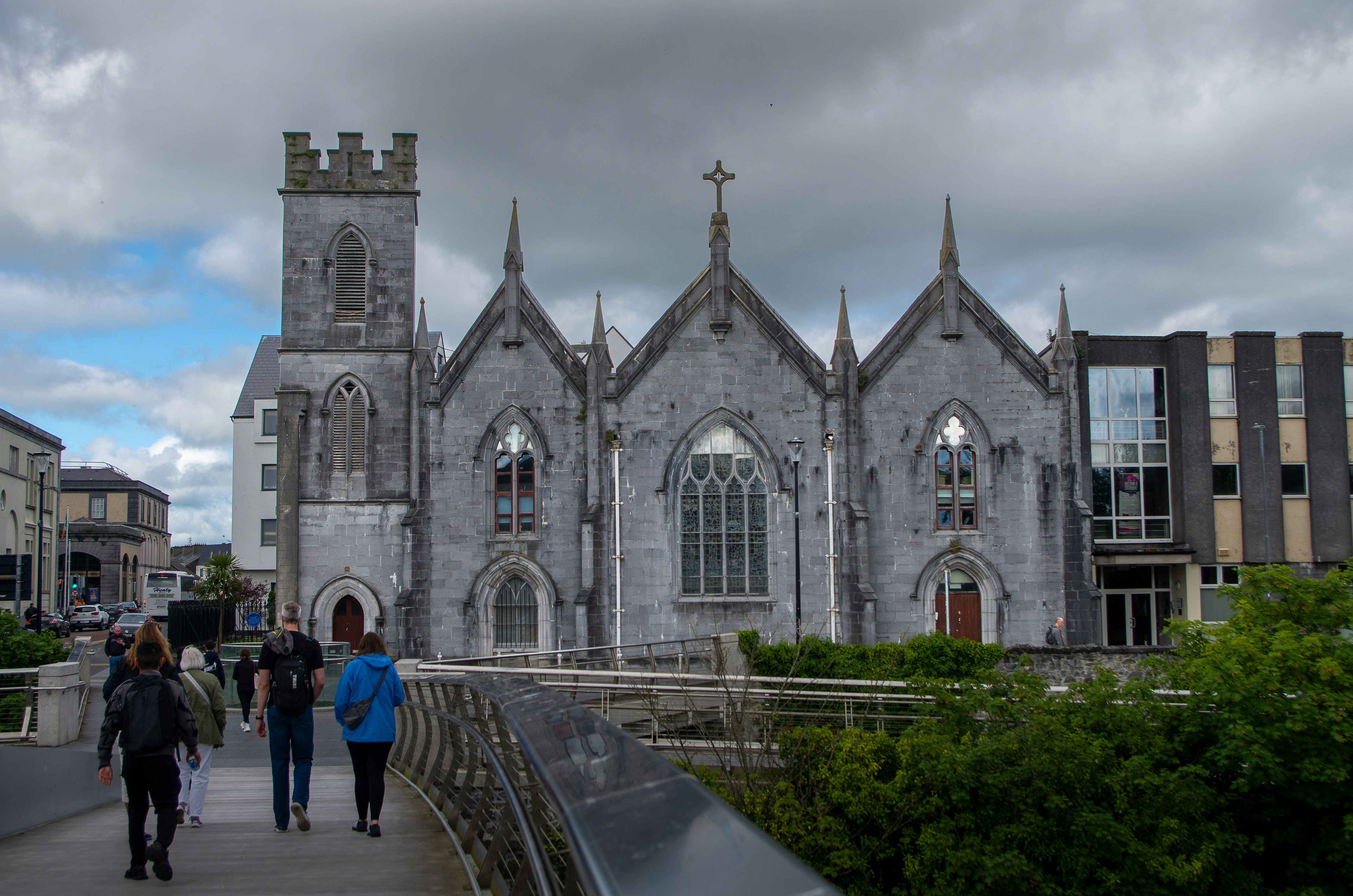 Historic stone church and tower with people on a walkway - free historic places to visit