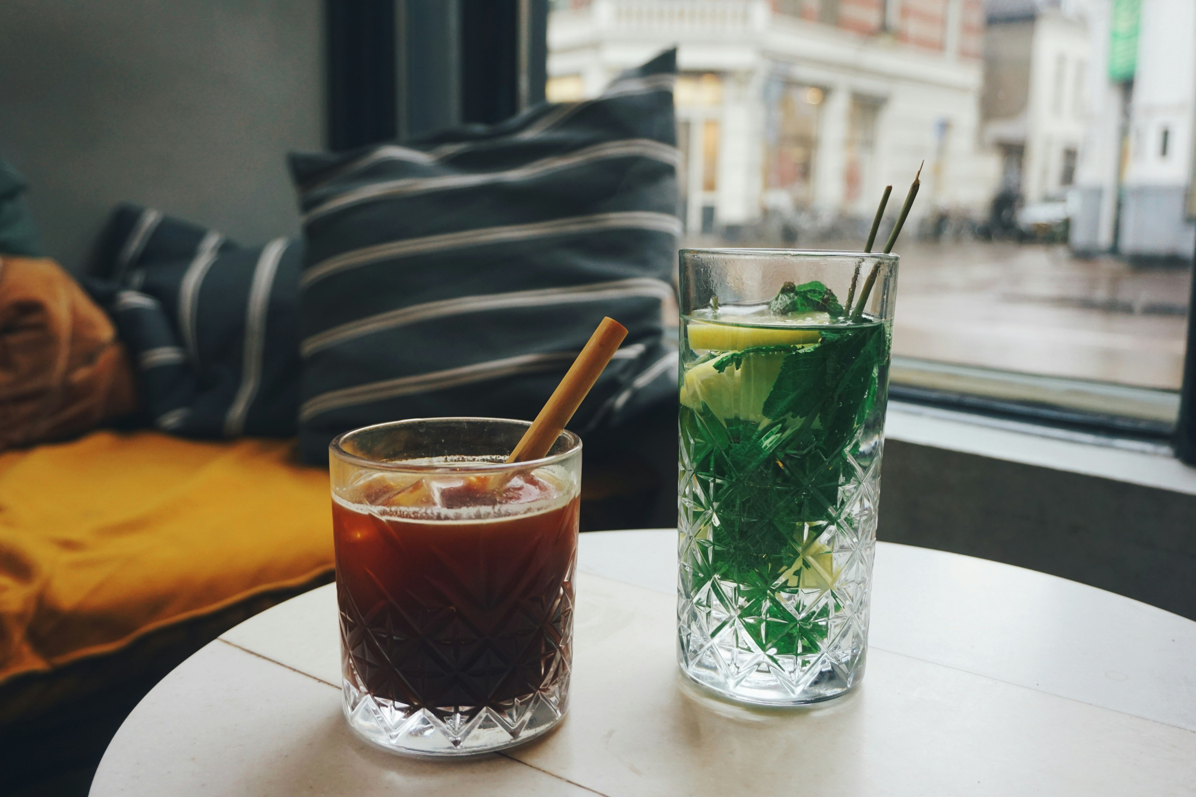 Iced coffee and a mint drink on a window table
