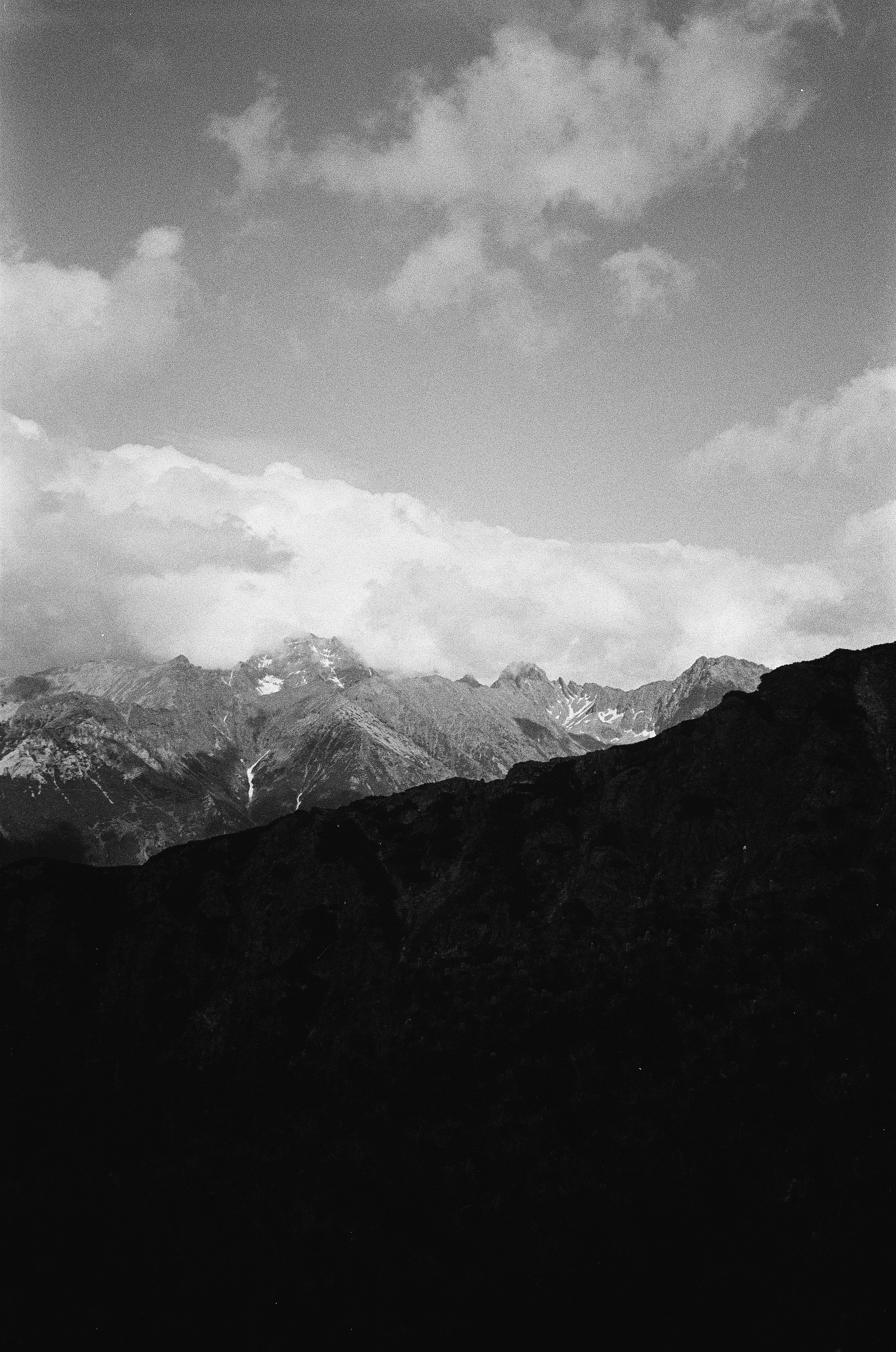 Dramatic black and white mountain landscape with clouds