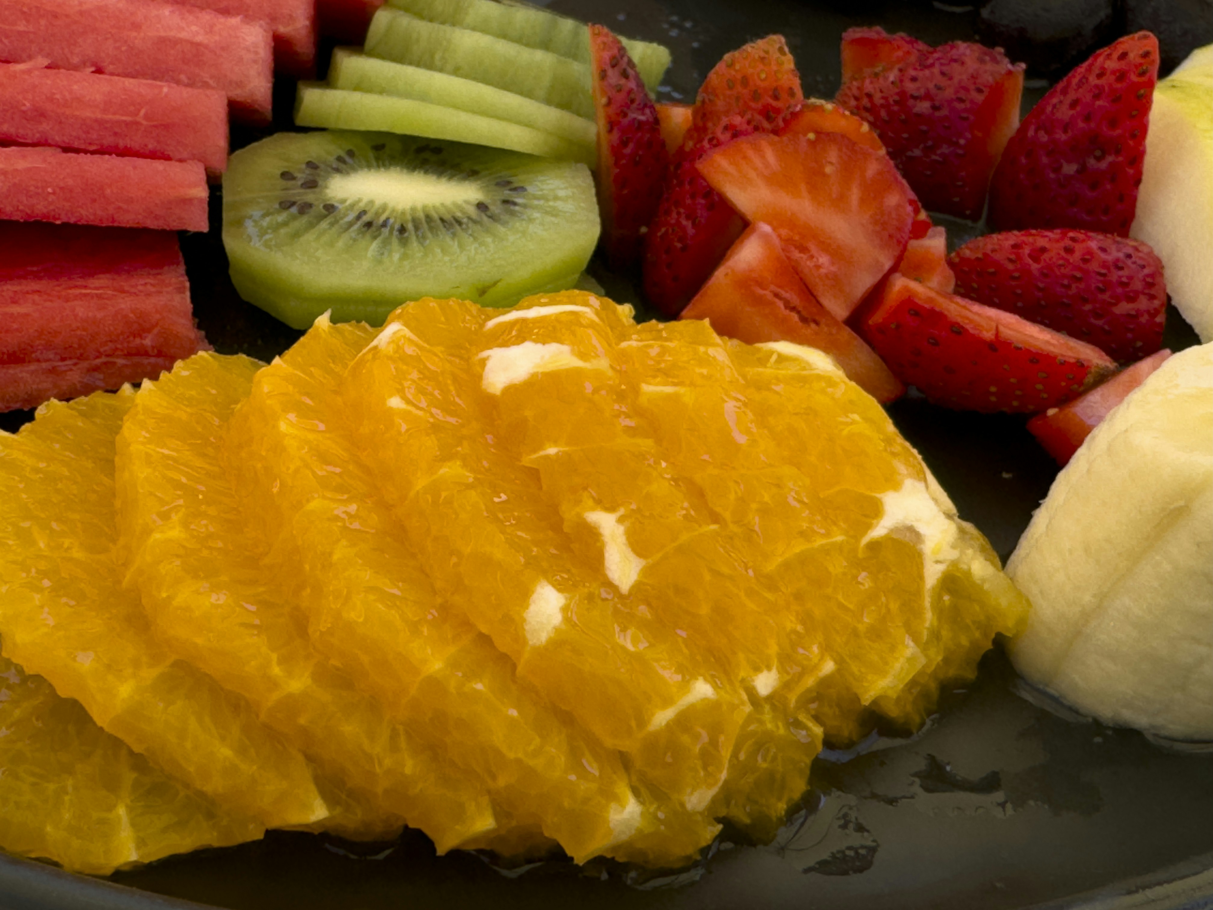 Fresh sliced oranges, kiwi, strawberries, and watermelon