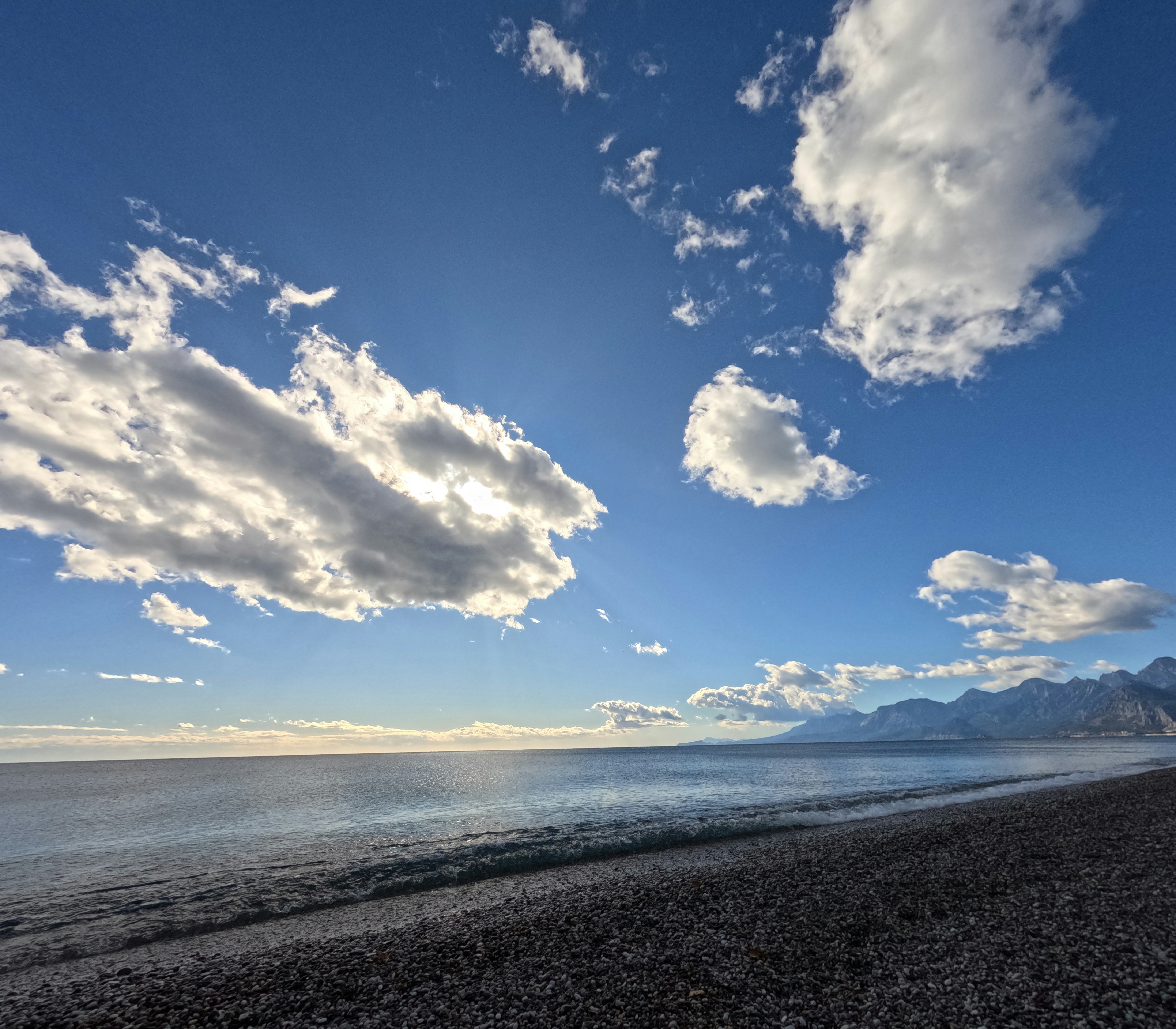 Antalya beach with calm sea and scattered clouds