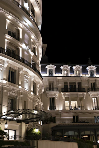 Elegant white buildings illuminated at night against dark sky