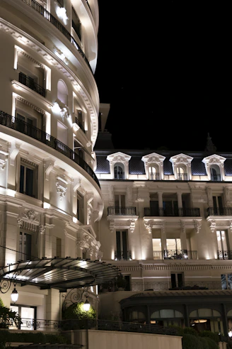 Elegant white buildings illuminated at night against dark sky