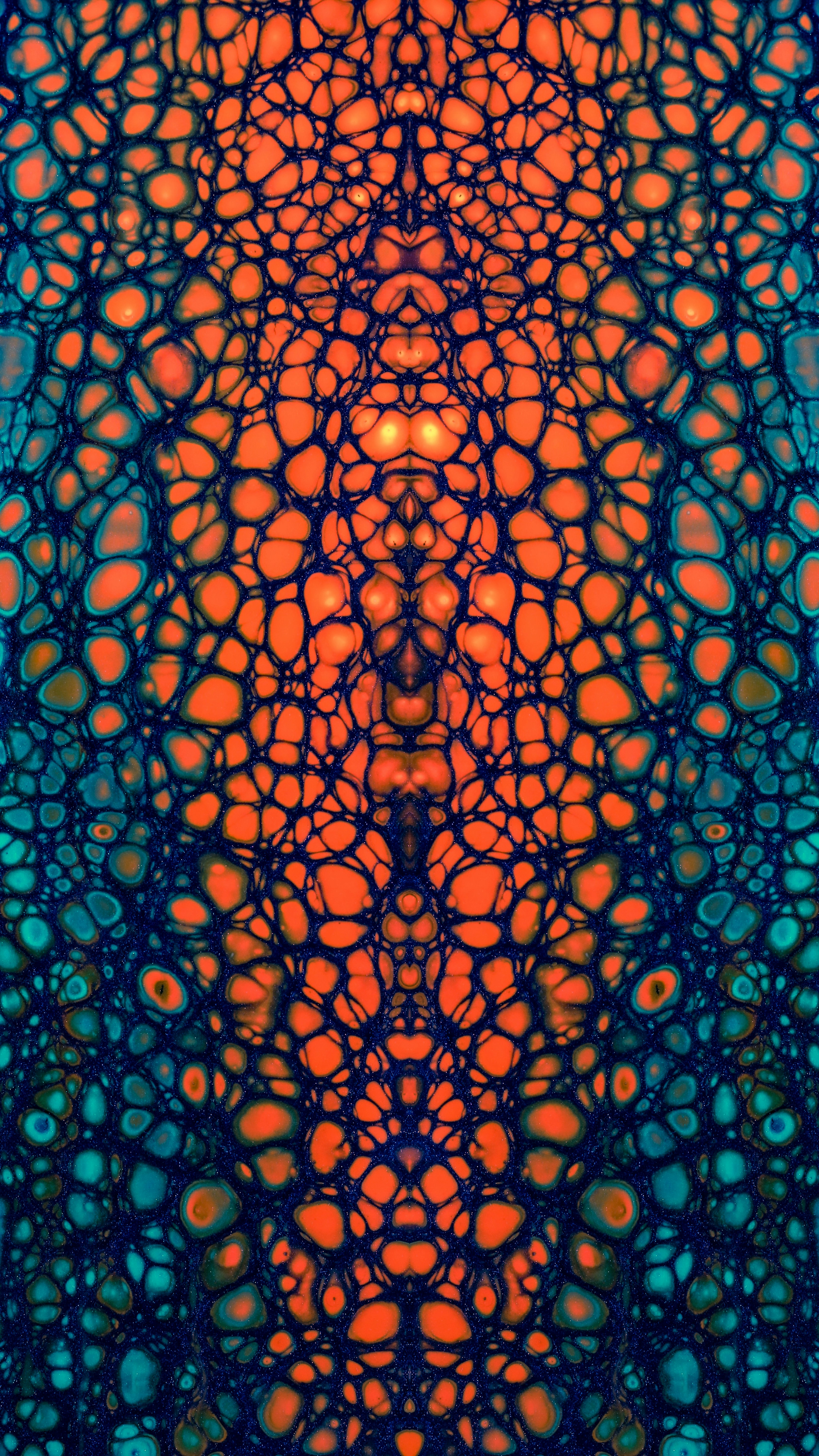 Symmetrical abstract cellular pattern in orange and blue