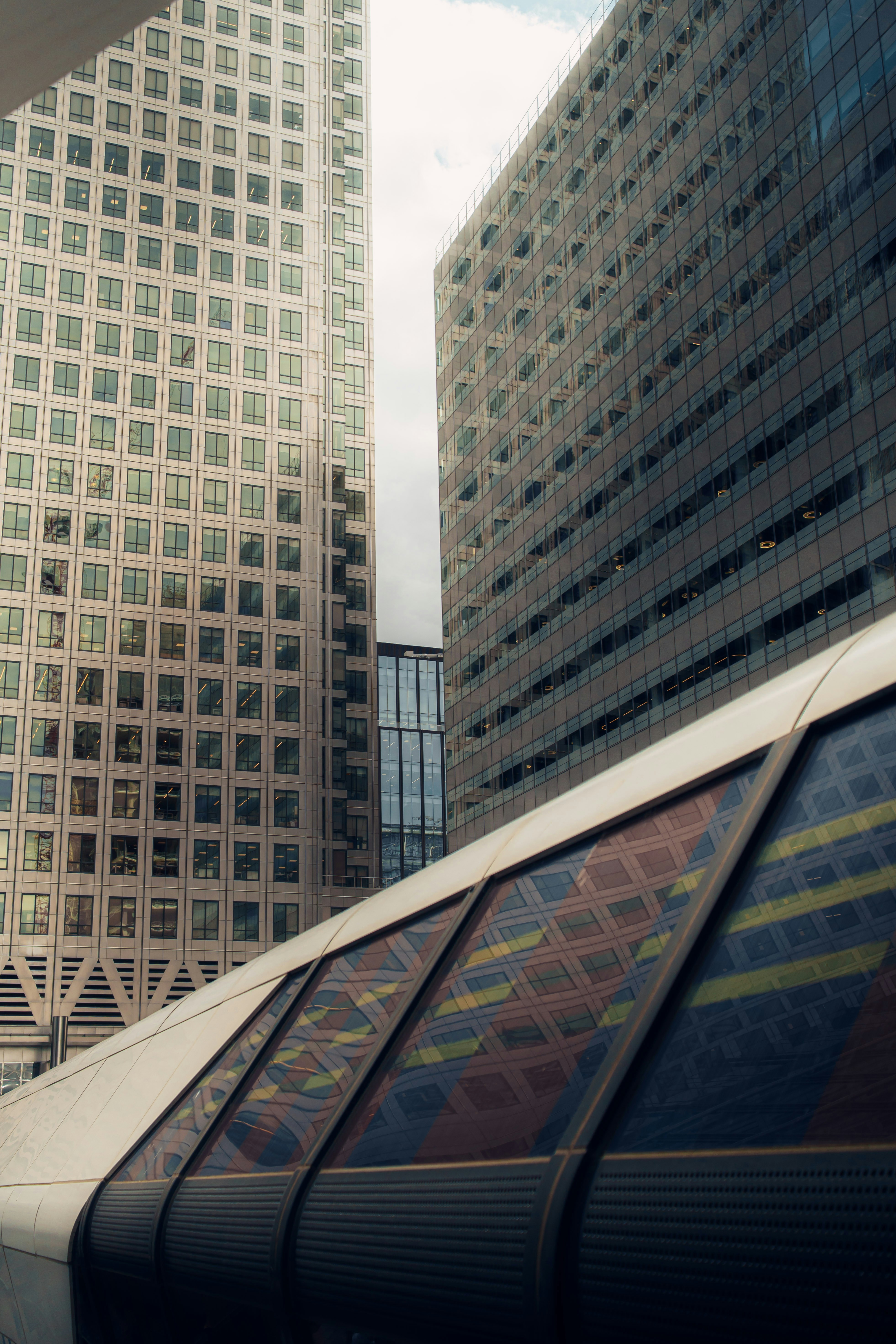Modern skyscrapers and a pedestrian walkway with colorful reflections.