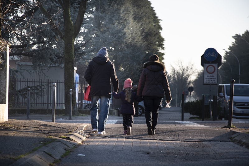 Parents and child walking hand in hand